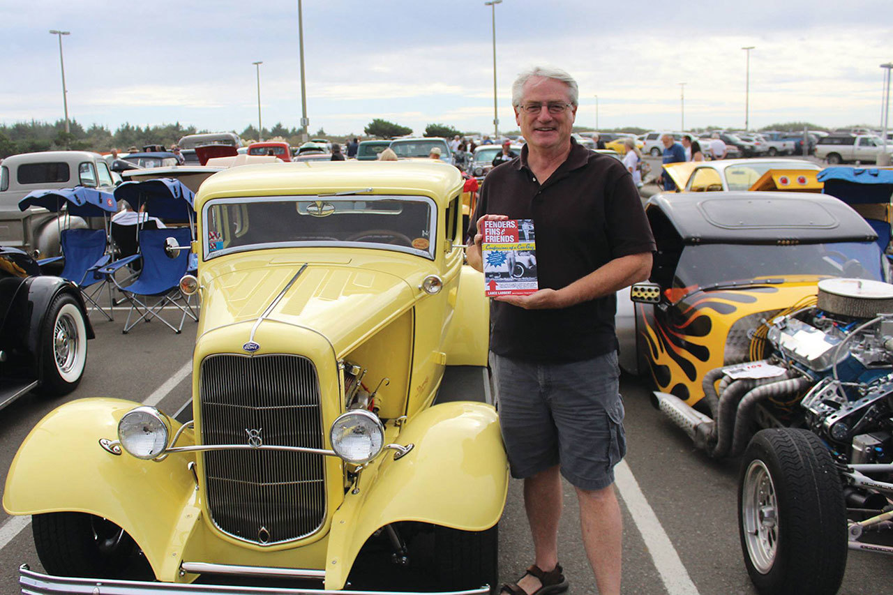 Angelo Bruscas/GH Newspaper Group                                Lance Lambert displays one of his books during a previous Show N’ Shine at the Shores event at the Quinault Beach Resort and Casino.