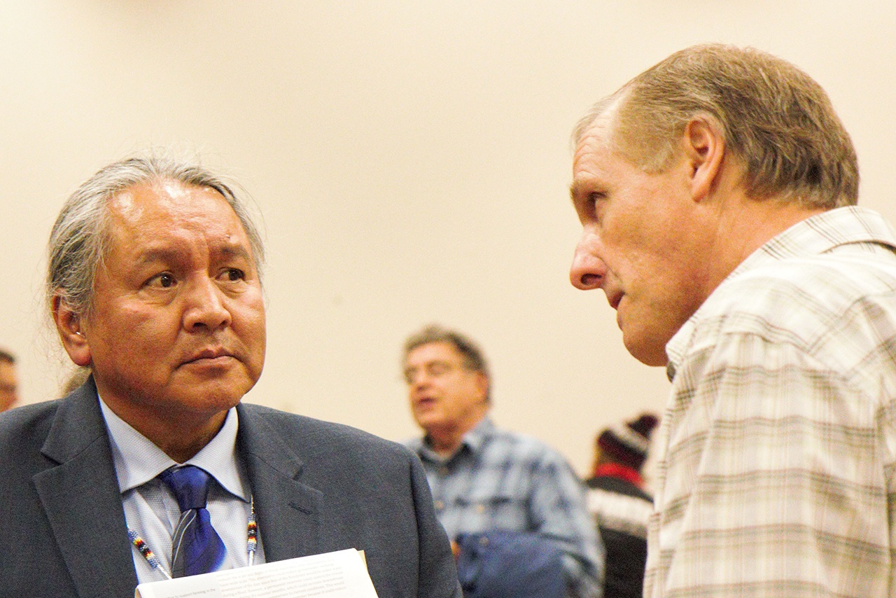 At the Chehalis Basis Strategy public hearing, held Oct. 27, in Montesano, Rodney Youckton, left, a proponent of Alternative 4 and fish habitat restoration, speaks with Al Zepp, a proponent of Alternative 1, and construction of a dam. (Stephanie Morton | The Vidette)