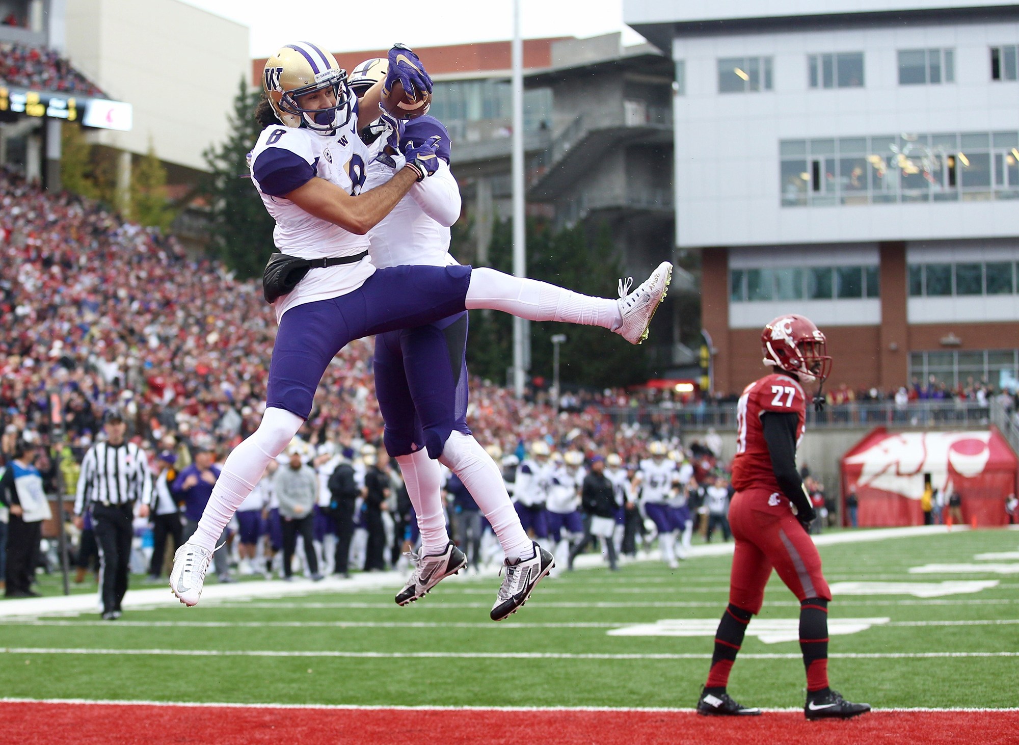 Washington’s Dante Pettis and John Ross celebrate Pettis’ touchdown in the first quarter to put the Huskies up 14-0 against Washington State in the 109th Apple Cup at Martin Stadium in Pullman, Wash., on Friday, Nov. 25, 2016. Washington won, 45-17. (Lindsey Wasson/Seattle Times/TNS)
