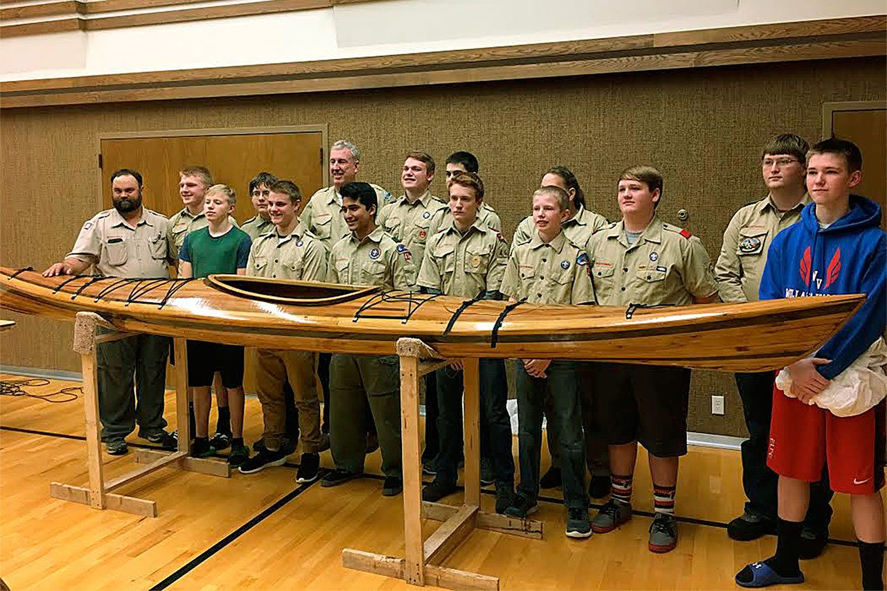 (Photo provided by Steve Holland) It took 19 months to construct the 17-foot kayak. Pictured from left are Scout Master Rex Angelovich, Peter Hamilton, Jed Western, Caleb Holland, Seth Angelovich, Tim Quigg, Carlos Cruz, Luke Hamilton, Marcus Anderson, Aidan Worlton, Terry Morris (obscured), Christopher Western, Marcus Pehl, Connor Bond and Sam Western.