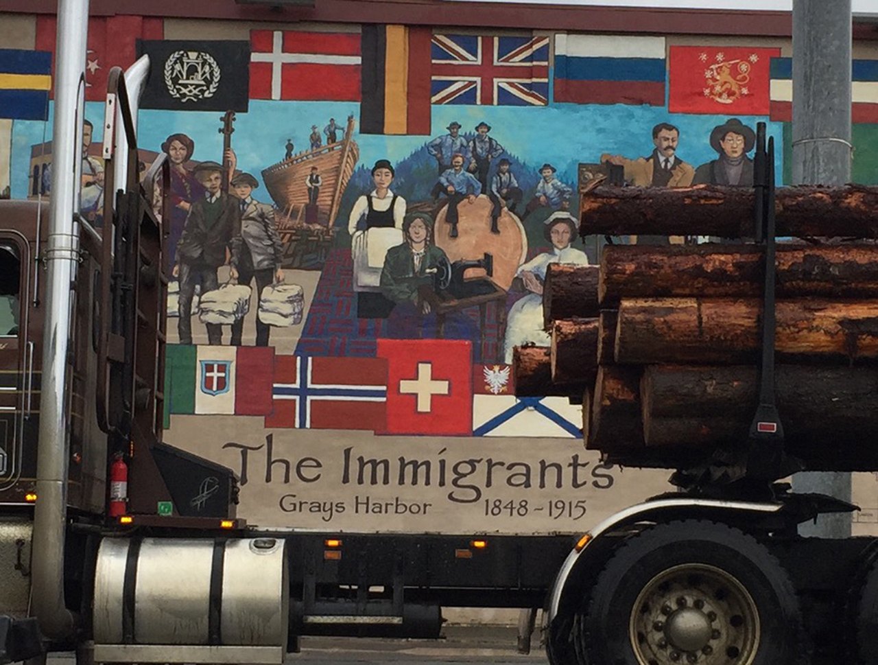 A logging truck is parked in front of a mural in Aberdeen. Many in the timber Washington timber industry voted for Donald Trump for president. (William Yardley/Los Angeles Times)