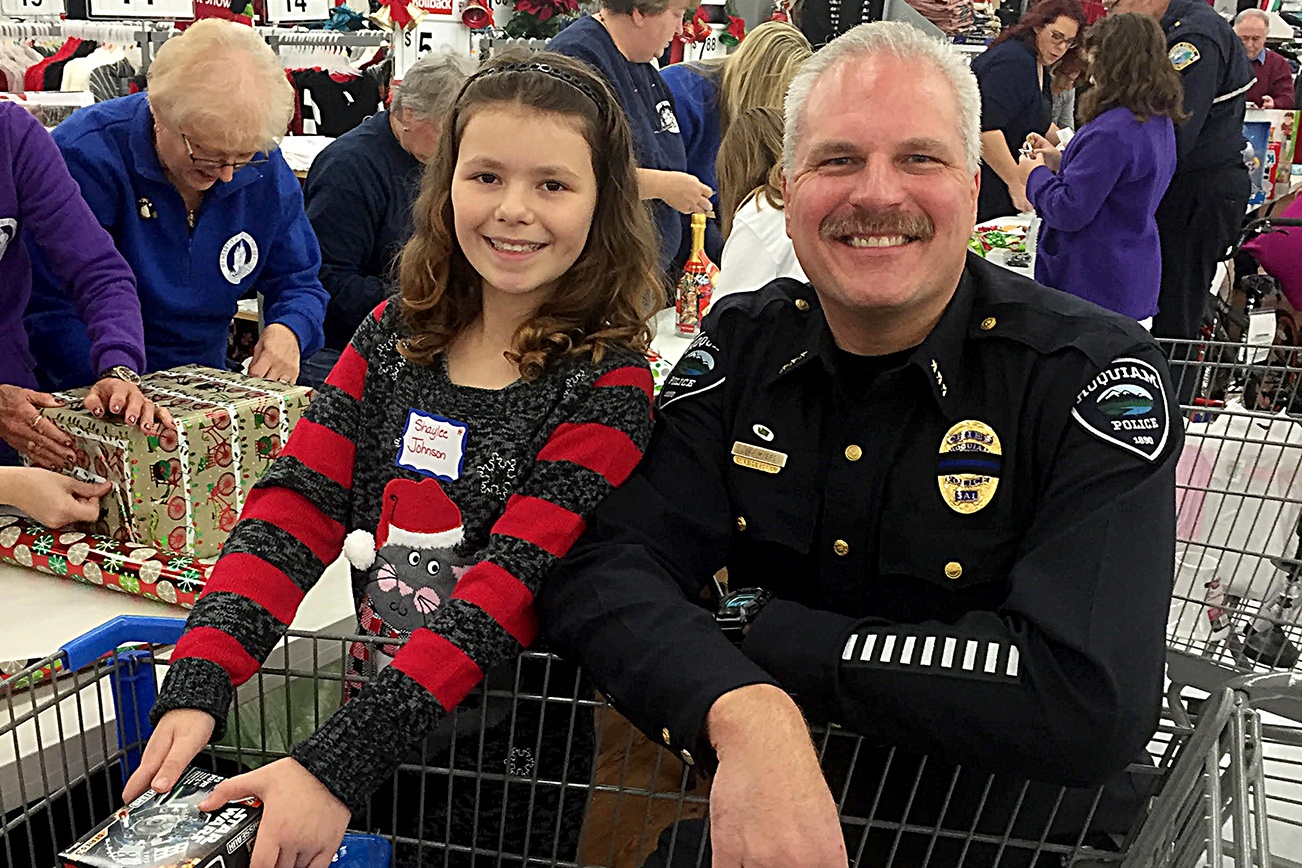 Hoquiam Police Chief Jeff Myers was among the area officers who participated in Saturday’s Shop with a Cop event. The project, in its 18th year, teams local law enforcement with kids selected by school principals from across the Harbor for breakfast at the Aberdeen Eagles, a ride in a department vehicle and $100 to spend at Walmart. Here Myers and his partner for the event, Shaylee Johnson, smile over a cart full of toys.