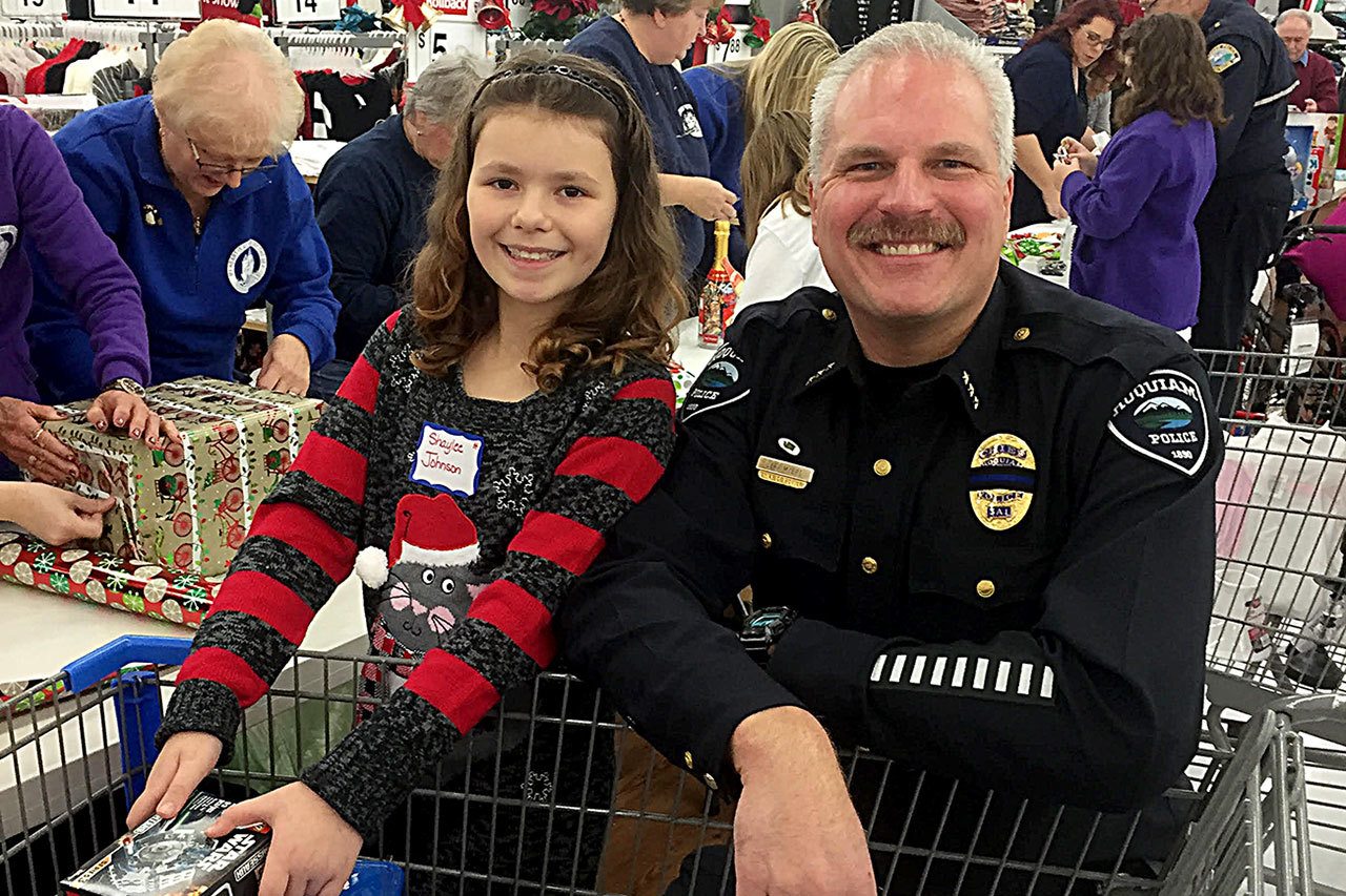 Hoquiam Police Chief Jeff Myers was among the area officers who participated in Saturday’s Shop with a Cop event. The project, in its 18th year, teams local law enforcement with kids selected by school principals from across the Harbor for breakfast at the Aberdeen Eagles, a ride in a department vehicle and $100 to spend at Walmart. Here Myers and his partner for the event, Shaylee Johnson, smile over a cart full of toys.