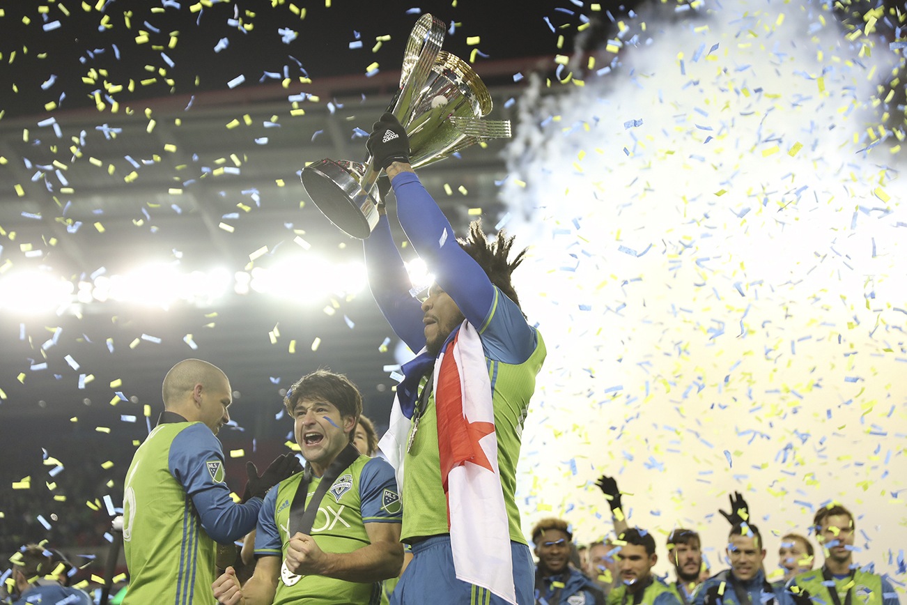 Dan Poss | Sounders FC Seattle Sounders FC Defender Román Torres hoists the MLS Cup trophy.