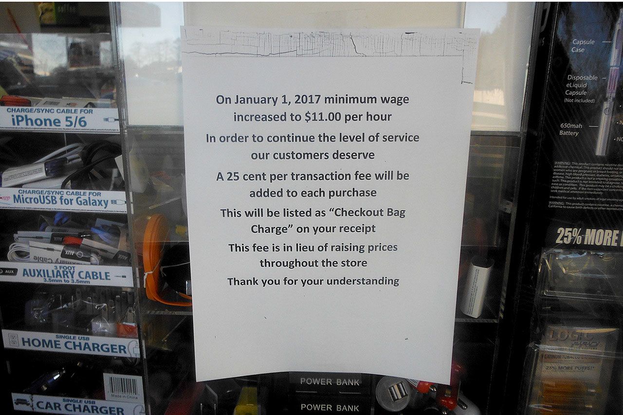 These signs started showing up at Aberdeen 7-11 stores during the first week of 2017. The owners of the local franchises have started charging an additional 25 cents for every transaction in an effort to offset the impact of the state’s new minimum wage. This particular sign was at the East Market Street store.                                 These signs started showing up at Aberdeen 7-11 stores during the first week of 2017. The owners of the local franchises have started charging an additional 25 cents for every transaction in an effort to offset the impact of the state’s new minimum wage. This particular sign was at the East Market Street store.