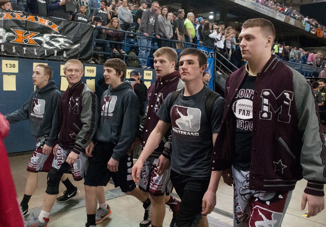 (Brendan Carl | The Daily World) Montesano’s Jacob Ellefson, left to right, Tyler Izatt, Tony Williams, Kylar Prante, Austin Cain and Taylor Rupe walk together during the walk of champions parade that is part of the ceremonies of the Mat Classic in February. The Bulldogs finished fourth as a team at the end of the two-day state wrestling tournament.
