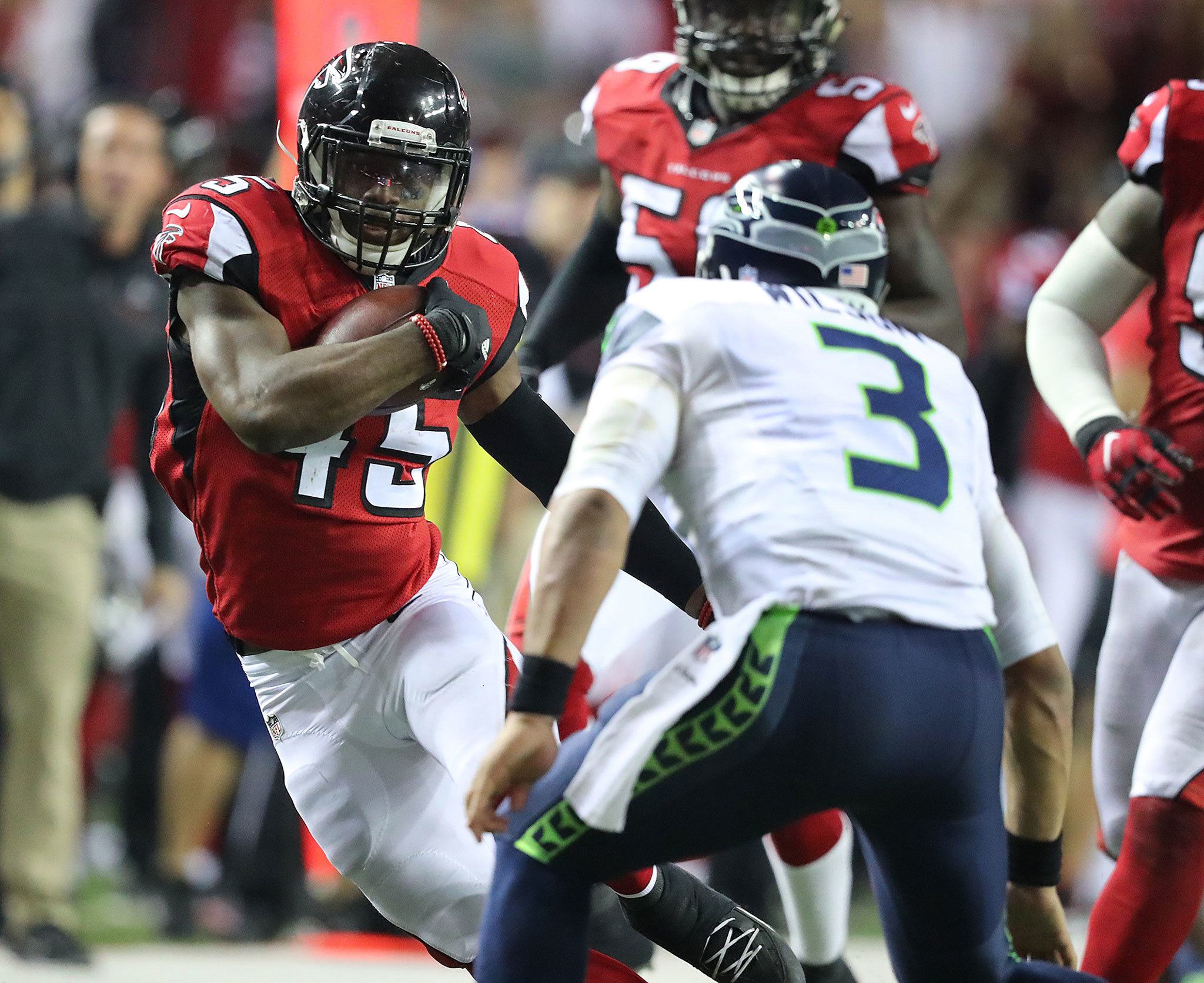 (Curtis Compton | Atlanta Journal-Constitution) Atlanta Falcons linebacker Deion Jones intercepted Seattle Seahawks quarterback Russell Wilson, who tried to make the tackle on Jones’ return run in the final minutes of the NFC Divisional Playoff on Saturday at the Georgia Dome in Atlanta. The Falcons won, 36-20.