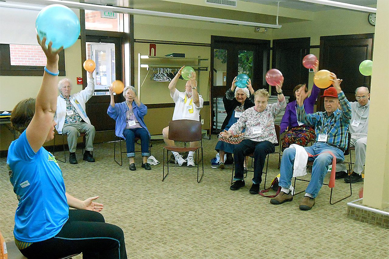 Physical Therapist Jamie Graves leads the Grays Harbor Parkinson’s Support Group in chair exercises using a ball and a towel. (BETSY SEIDEL PHOTO)