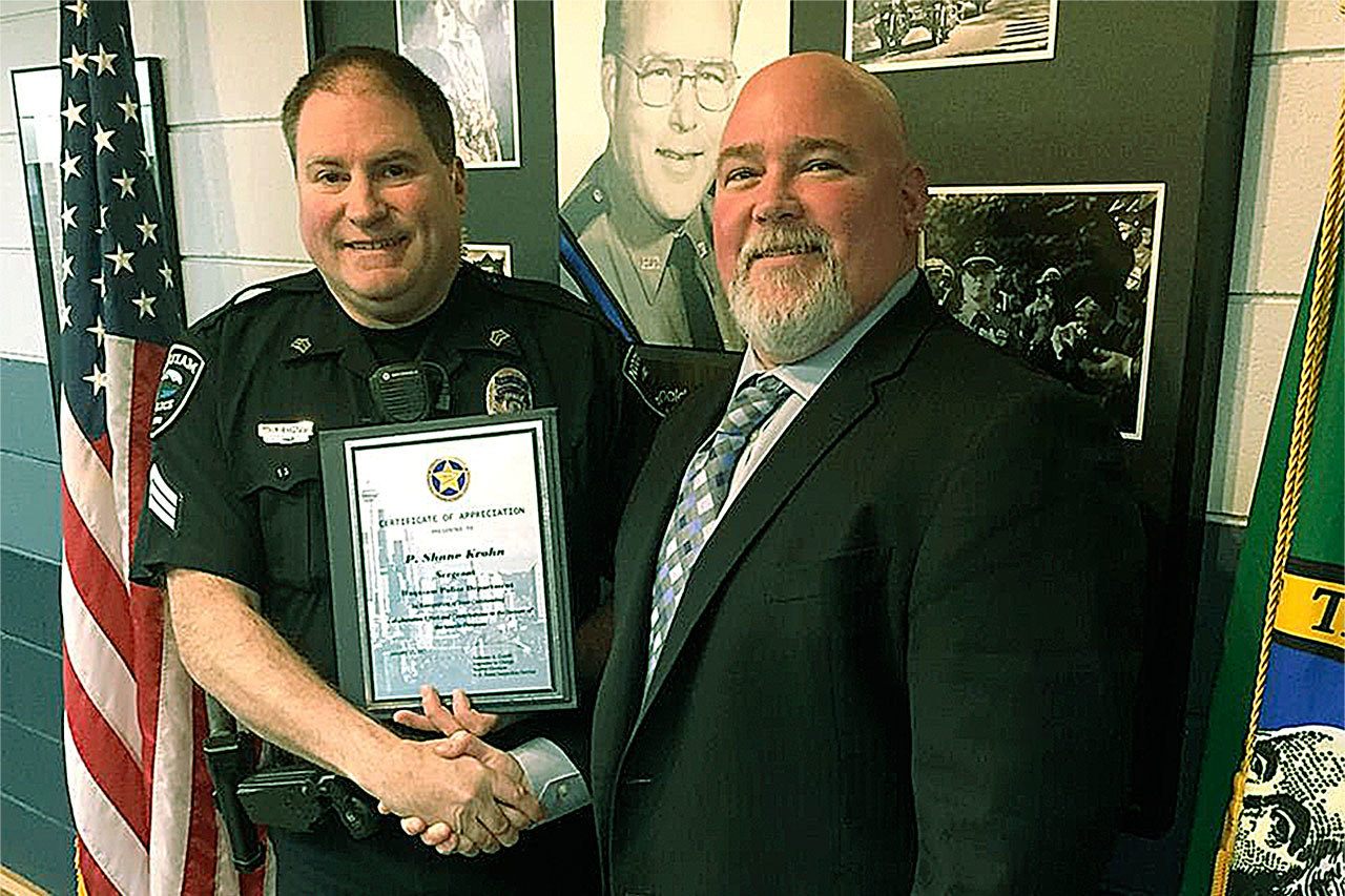 Sgt. Shane Krohn with the Hoquiam Police Department receives a letter of appreciation from Anthony Galetti, Inspector in Charge, Seattle Division, U.S. Postal Service. (HOQUIAM POLICE DEPARTMENT PHOTO)