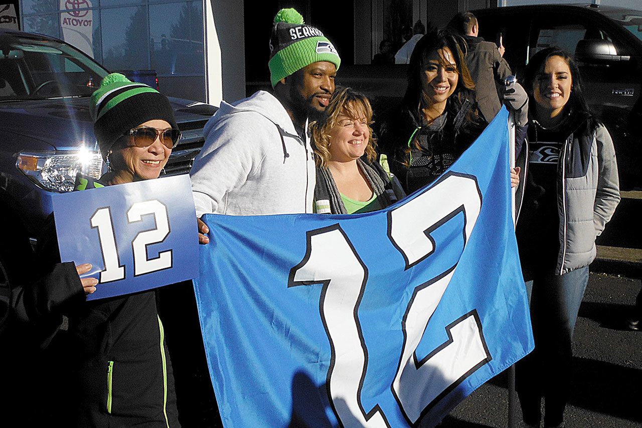 The Seattle Seahawks “Road to the Playoffs” tour made a stop in Grays Harbor County early Wednesday afternoon. The crew that brought the 12th Man flag included Seahawks DJ Supa Sam and retired Seahawks cheerleaders Jessica I. and Gelly and posed for pictures with the 50 or so fans who showed up at Five Star Toyota. The flag is the one that is carried onto the field before each game. Earlier in the day a good number of fans met the tour at Raymond city hall. The Seahawks take on the Detroit Lions at Centurylink Field Saturday in round one of the NFC playoffs.                                 The Seattle Seahawks “Road to the Playoffs” tour made a stop in Grays Harbor County early Wednesday afternoon. The crew that brought the 12th Man flag included Seahawks DJ Supa Sam and retired Seahawks cheerleaders Jessica I. and Gelly and posed for pictures with the 50 or so fans who showed up at Five Star Toyota. The flag is the one that is carried onto the field before each game. Earlier in the day a good number of fans met the tour at Raymond city hall. The Seahawks take on the Detroit Lions at Centurylink Field Saturday in round one of the NFC playoffs.                                 The Seattle Seahawks “Road to the Playoffs” tour made a stop in Grays Harbor County early Wednesday afternoon. The crew that brought the 12th Man flag included Seahawks DJ Supa Sam and retired Seahawks cheerleaders Jessica I. and Gelly and posed for pictures with the 50 or so fans who showed up at Five Star Toyota. The flag is the one that is carried onto the field before each game. Earlier in the day a good number of fans met the tour at Raymond city hall. The Seahawks take on the Detroit Lions at Centurylink Field Saturday in round one of the NFC playoffs.                                 The Seattle Seahawks “Road to the Playoffs” tour made a stop in Grays Harbor County early Wednesday afternoon. The crew that brought the 12th Man flag included Seahawks DJ Supa Sam and retired Seahawks cheerleaders Jessica I. and Gelly and posed for pictures with the 50 or so fans who showed up at Five Star Toyota. The flag is the one that is carried onto the field before each game. Earlier in the day a good number of fans met the tour at Raymond city hall. The Seahawks take on the Detroit Lions at Centurylink Field Saturday in round one of the NFC playoffs.