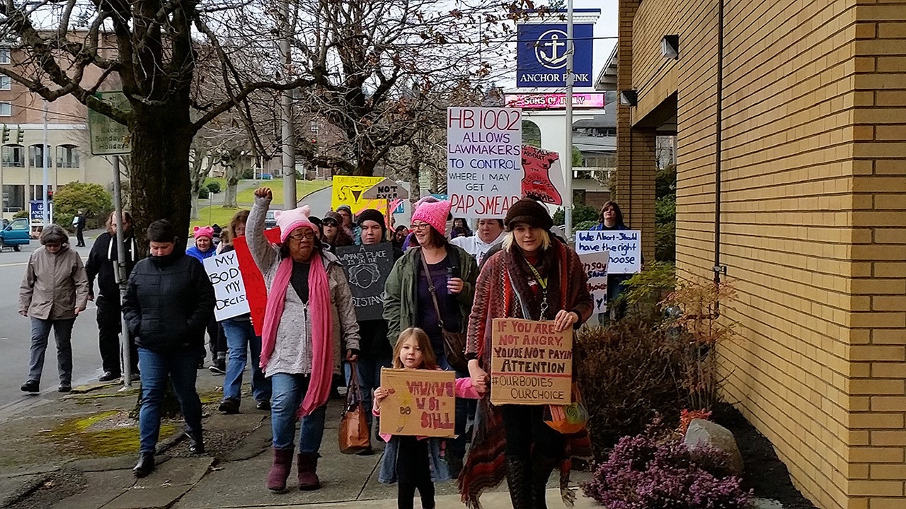 About 70 demonstrators against State Legislative House Bills 1002 and 1003 marched in downtown Aberdeen on Saturday. One of the bills focuses on restricting state employee insurance coverage on abortions and the other requires parental consent for minors seeking these procedures. (Terri Harber|The Daily World)