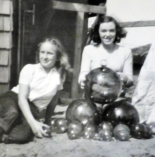 Jane Eide with Vonnie (at right) showing off the floats she found on the Grayland Beach during one summer vacation in the late 1940s. VONNIE THORPE COLLECTION