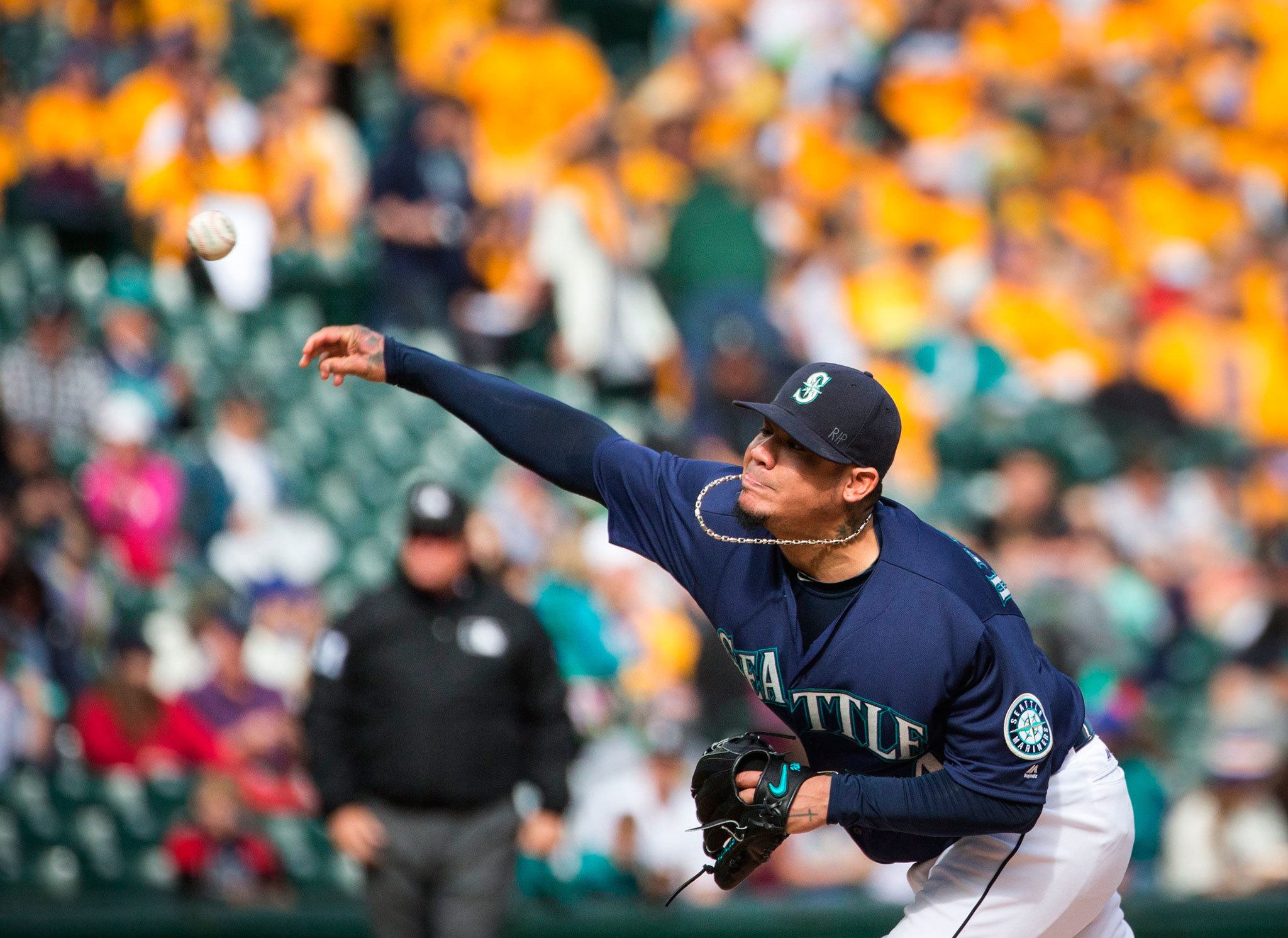 (Lindsey Wasson | Seattle Times) Seattle’s Felix Hernandez, seen here throwing a pitch during the final game of the 2016 season against Oakland in Seattle, will be one of the many pitchers and catchers who’ll report to spring training today in Arizona.