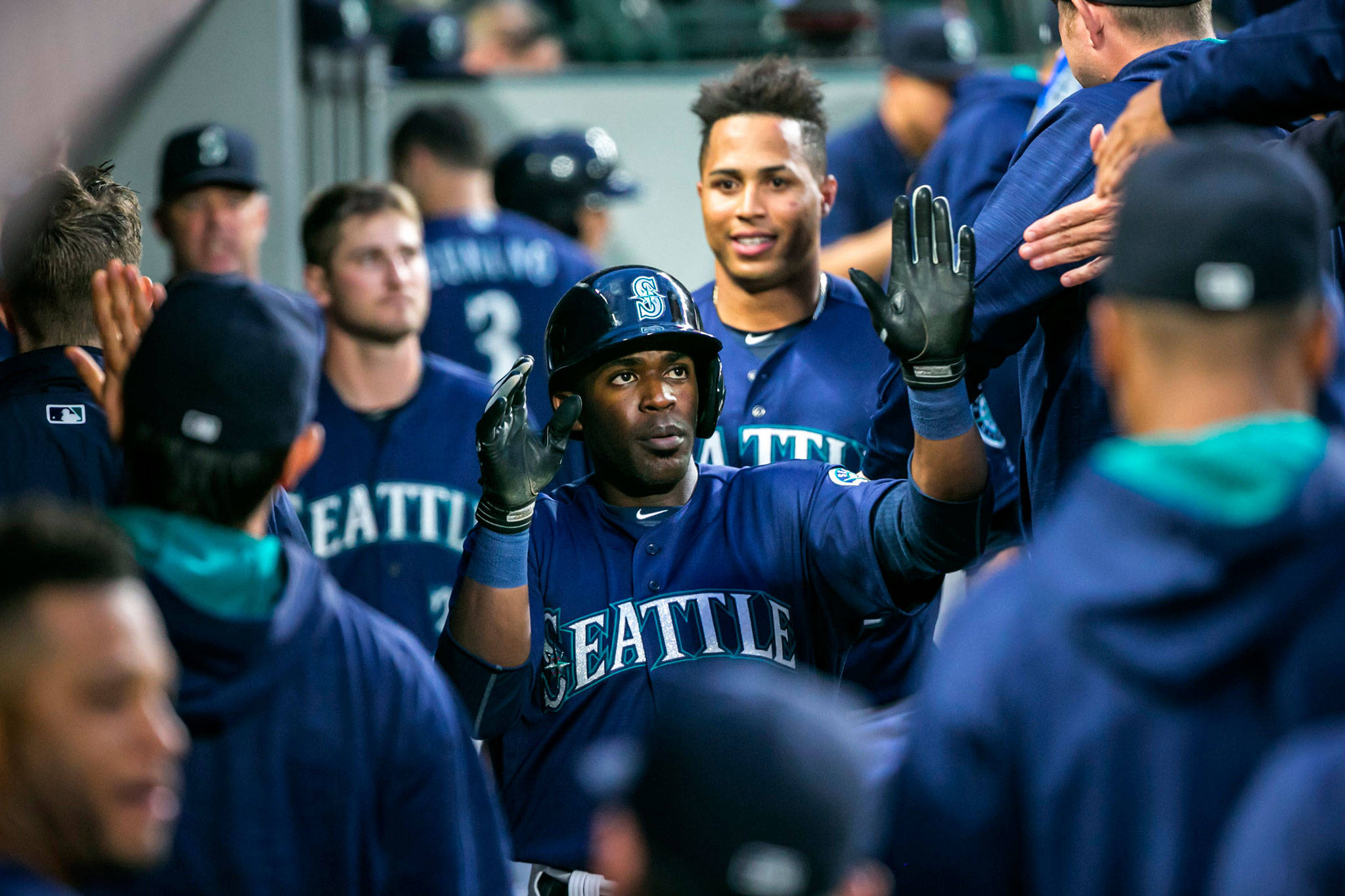 (Bettina Hansen | Seattle Times) Seattle’s Guillermo Heredia, seen here getting congratulated for scoring a run against Texas last season, is more confident entering Spring Training and is aiming for an Opening Day roster spot.