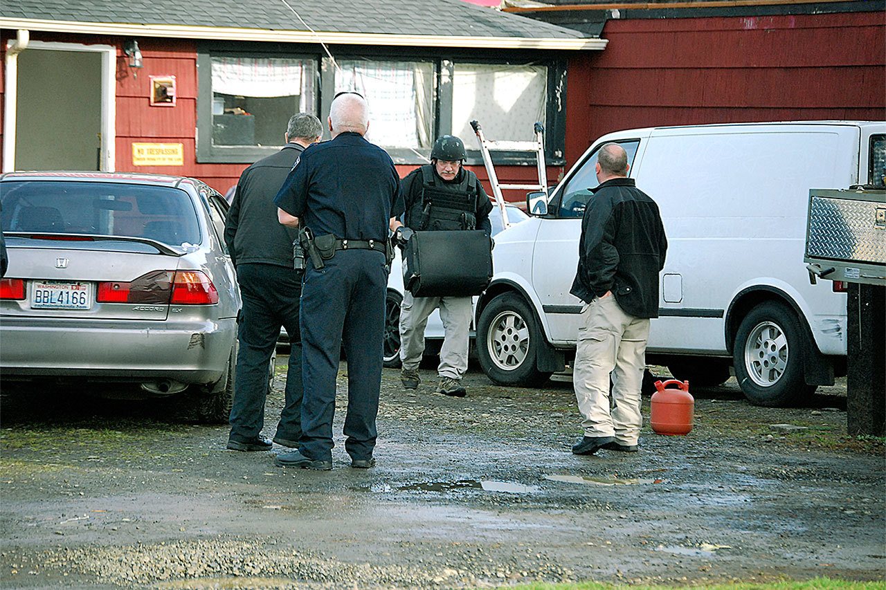 A member of the Washington State Patrol Bomb Squad Unit removes a suspicious device from the home on Wheeler Avenue in Hoquiam. (BOB KIRKPATRICK|THE DAILY WORLD)