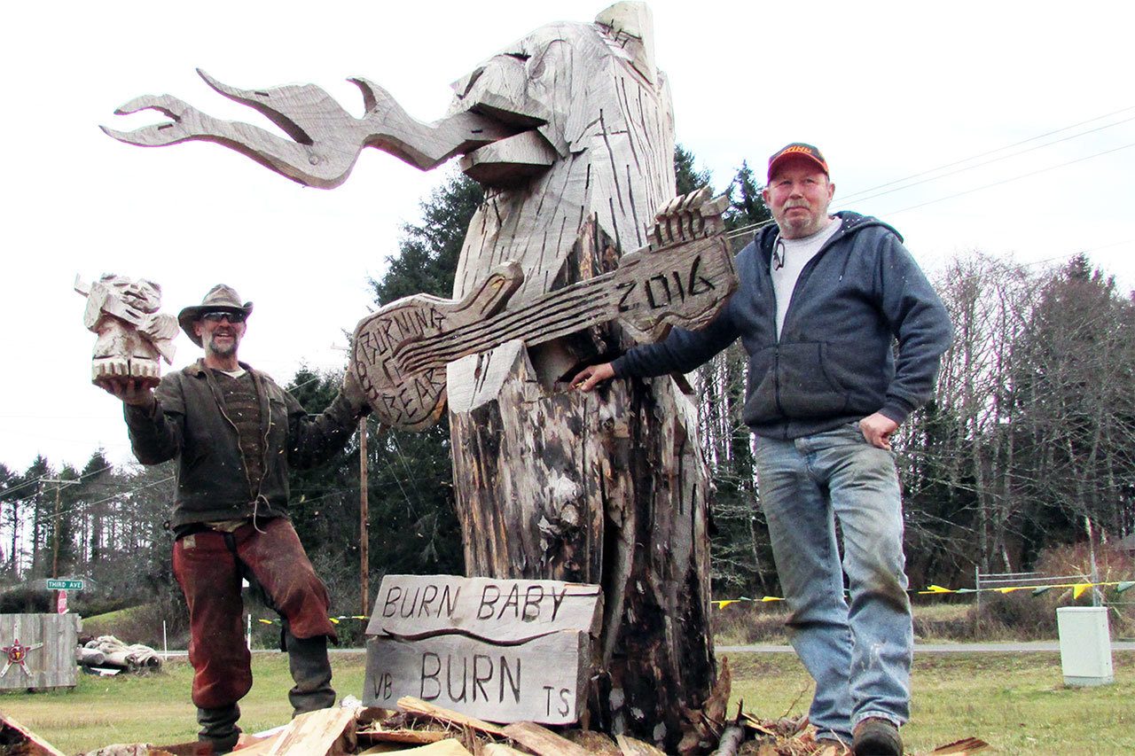 Burning Bear co-founder Ivan Hass, right, and carver James Haskett, of Butte, MT, look forward to lighting up the massive wooden sculpture Saturday around dusk at the event held at Ocean City Marketplace on SR 109.