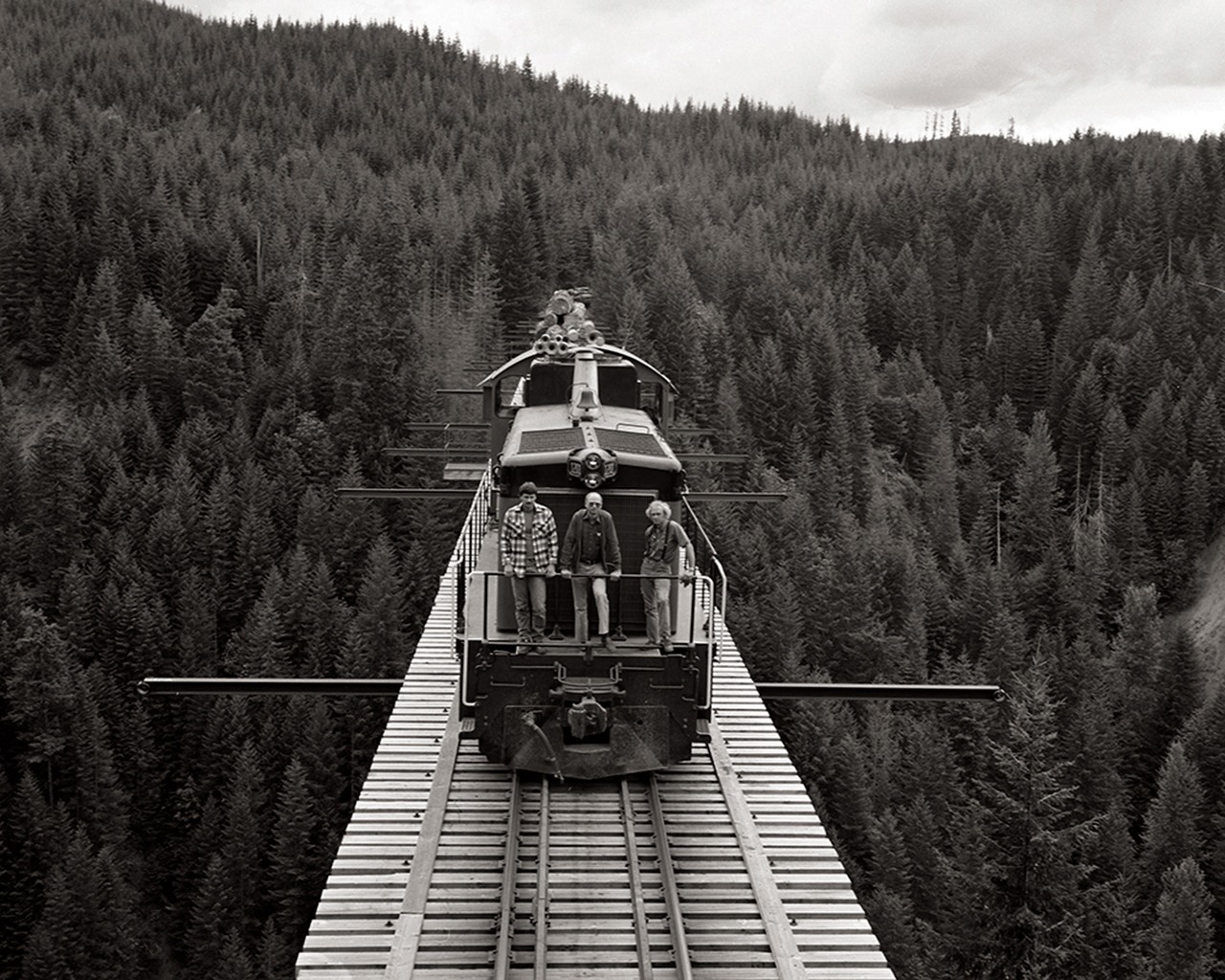 A photo taken by John Tylczak from the top of a caboose on the Simpson Logging Company’s Vance Creek railroad bridge, Aug. 9, 1985. From left to right, Simpson railroad crew members Todd Young, Pete Replinger and Ed Nelson.