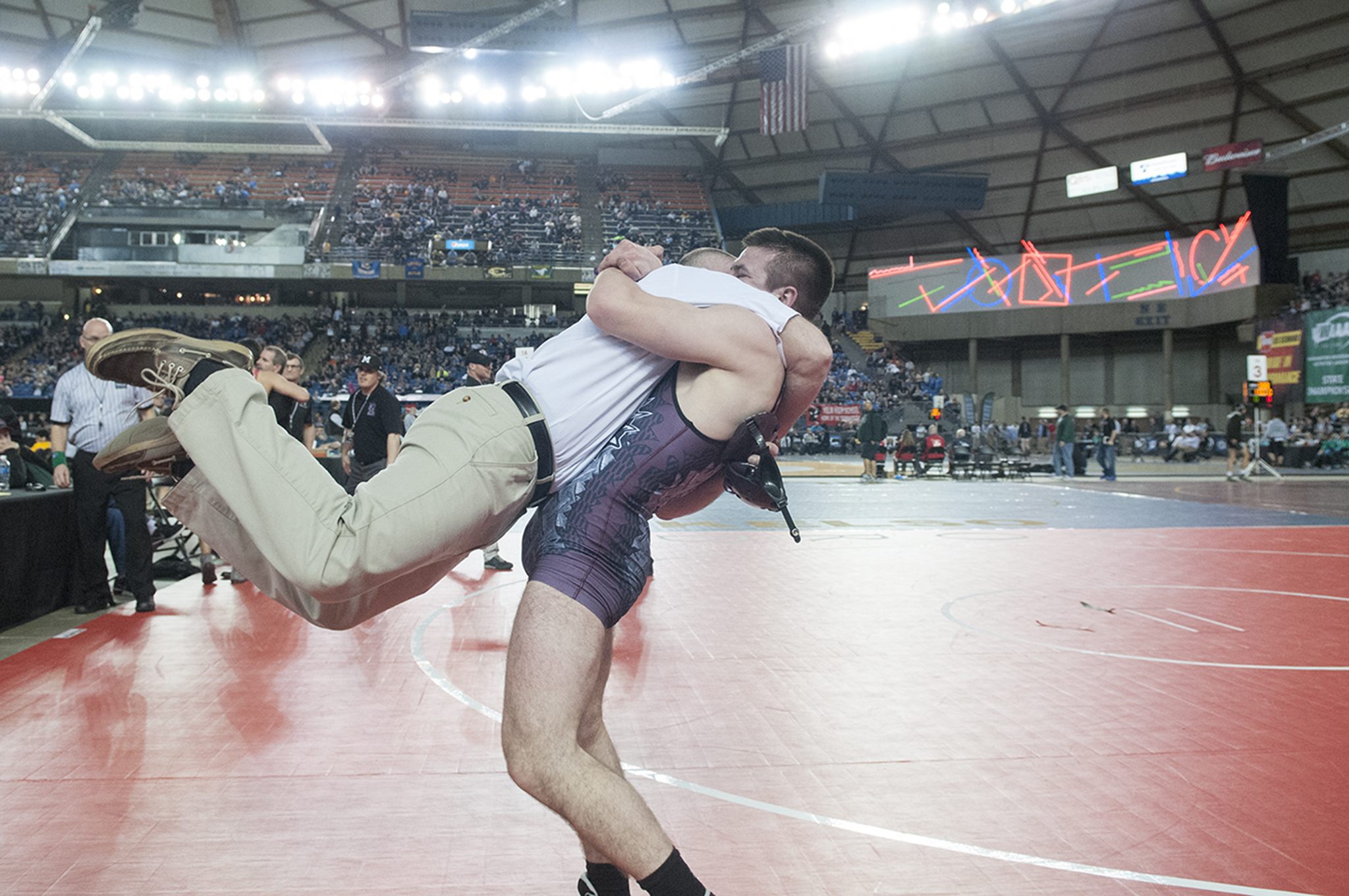 (Brendan Carl | The Daily World) Montesano’s Austin Cain lifts his father, Darold, off the ground as the two celebrate Cain winning the 1A state title for 160-pounds on Saturday.