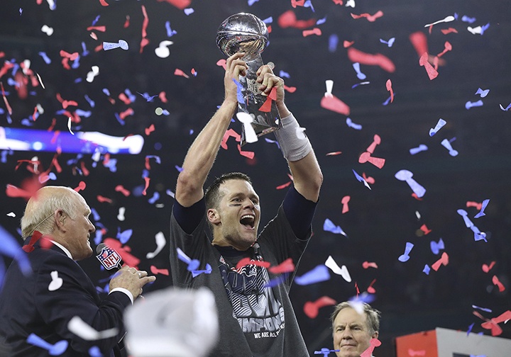 Tom Brady hoists the Lombardi Trophy, winning his fifth Super Bowl title, as the New England Patriots beat the Atlanta Falcons 34-28 in Super Bowl LI on Sunday at NRG Stadium in Houston, Texas. (Curtis Compton | Atlanta Journal-Constitution)