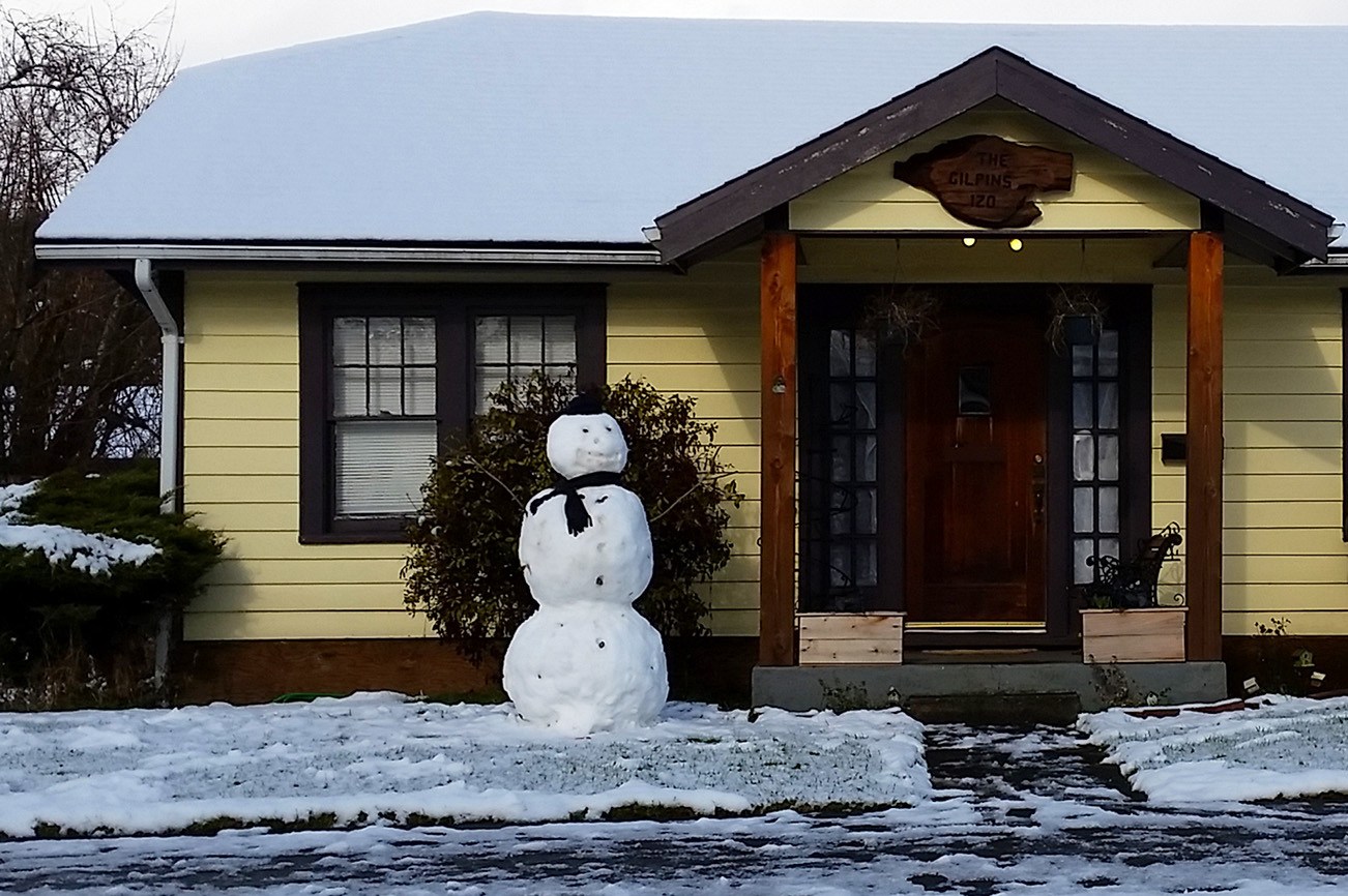 A snowman wears a hat and scarf near the intersection of Spruce and North Main Streets in Montesano on Monday afternoon. (Terri Harber|Grays Harbor Newspaper Group)