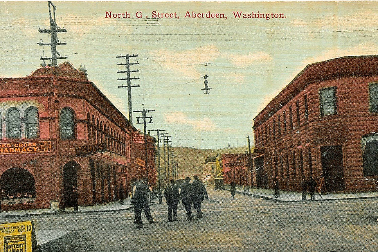Roy Vataja Collection                                A view looking north on G Street at Heron in October 1910. The sign is advertising “The Lottery Man’’, a comedy play performed at the Grand Theater. On the left is the Red Cross Pharmacy, better-known today as Billy’s Bar & Grill. Across the street, on the right, was the Hayes & Hayes bank building. This is the view of the city that John Yuko would have seen from the doorway of the White Eagle Saloon before succumbing to “whiskey heart” in November, 1910.