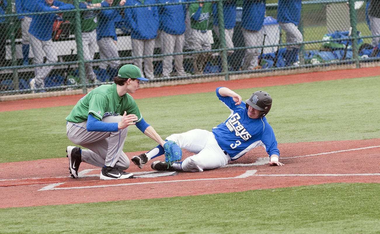 (Brendan Carl | The Daily World) Grays Harbor College’s Justyn Ekness tries to slide under the tag of Big Bend pitcher Austin Pesicka during an NWAC game at the RAC in Lacey on Saturday.