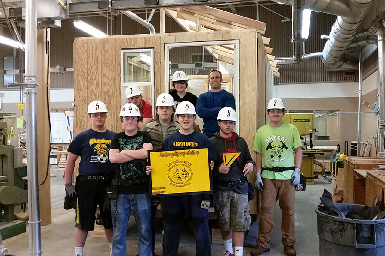 Aberdeen High School’s advanced construction class: Top row, from left C.J. Oldham (in window), Amy Twibell, and instructor Cory Martinsen. (Front, also from left) David Housden, Eric Haven, Jason Hansen, Elias Jimenez, Alex Reyes and Jared Eaton. (TERRI HARBER|THE DAILY WORLD)