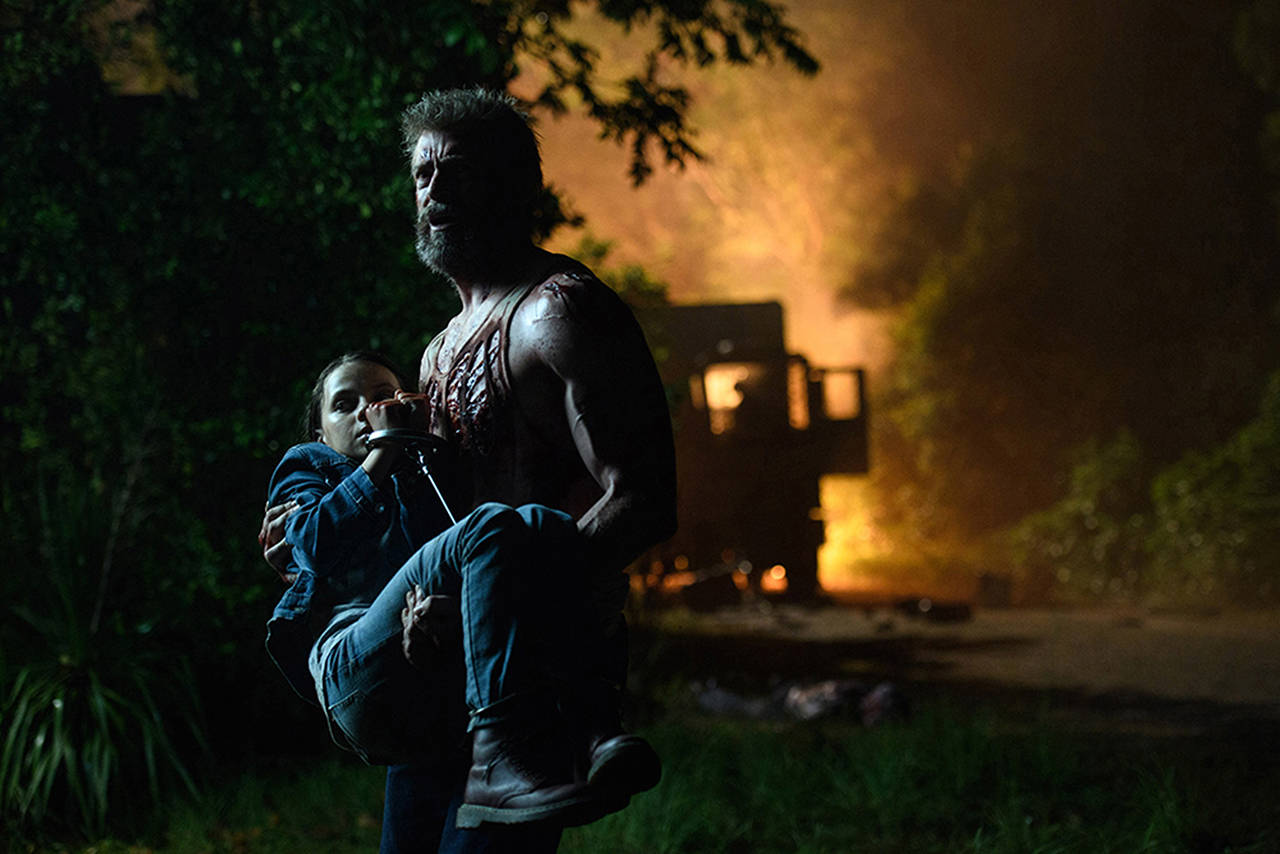 Logan/Wolverine (Hugh Jackman) tries to protect the young mutant Laura (Dafne Keen) in “Logan.” (Ben Rothstein/20th Century Fox)