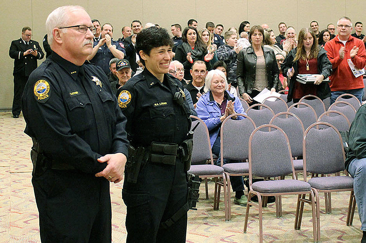 Retiring Ocean Shores Police Chief Mike Styner, left, and newly named replacement, Dep. Chief Neccie Logan get an ovation during the City Council meeting in which it was announced Styner would retire at the end of March after 35 years of service. (ANGELO BRUSCAS|GH NEWSPAPER GROUP)