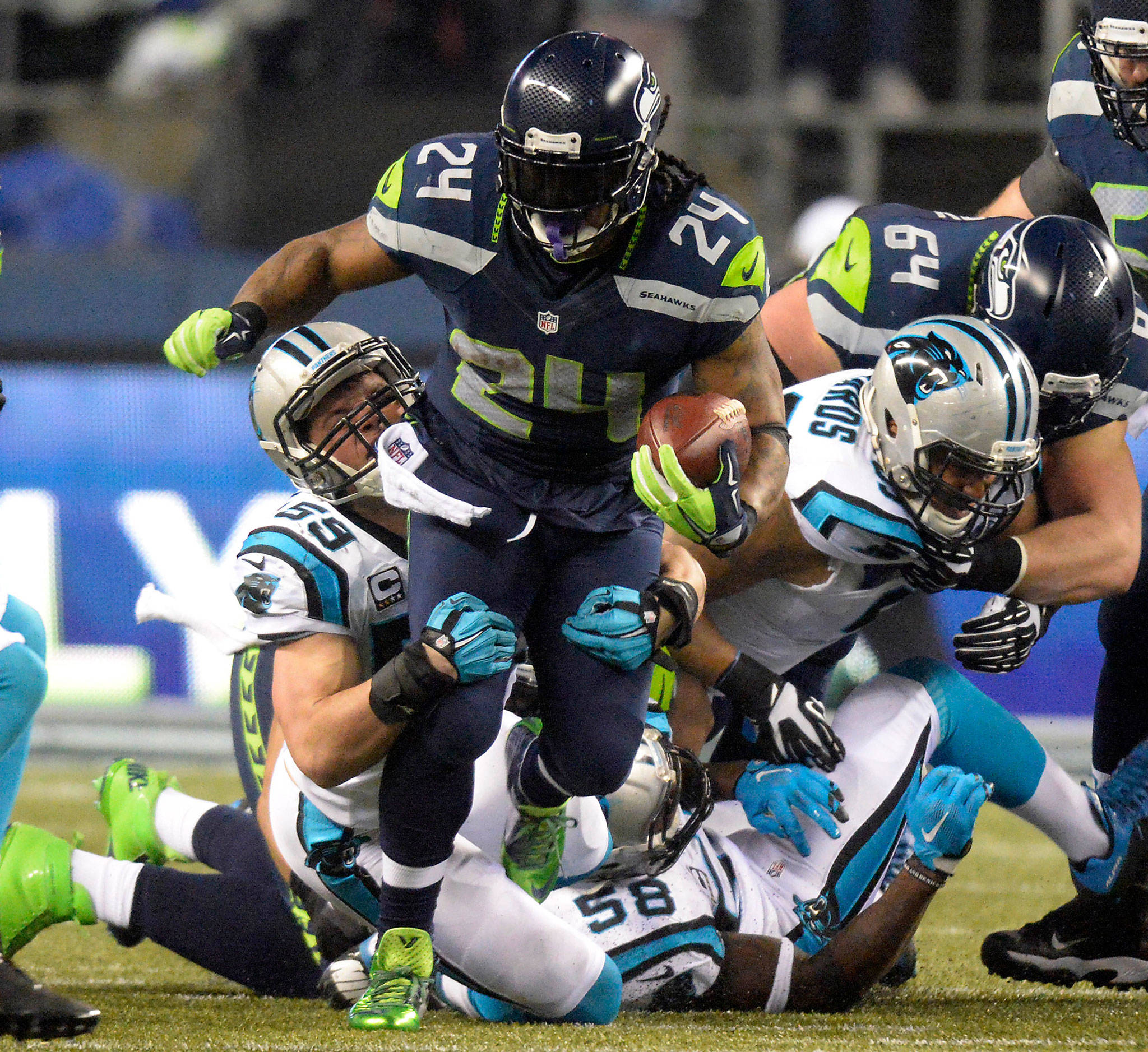 (David T. Foster, III | Charlotte Observer) Marshawn Lynch, seen here running against the Carolina Panthers during the 2014 NFC Divisional playoffs at CenturyLink Field in Seattle, is still retired from the NFL. However, the Oakland Raiders may possibly trade for his rights, just in case Lynch wants to return to the game with his hometown team.
