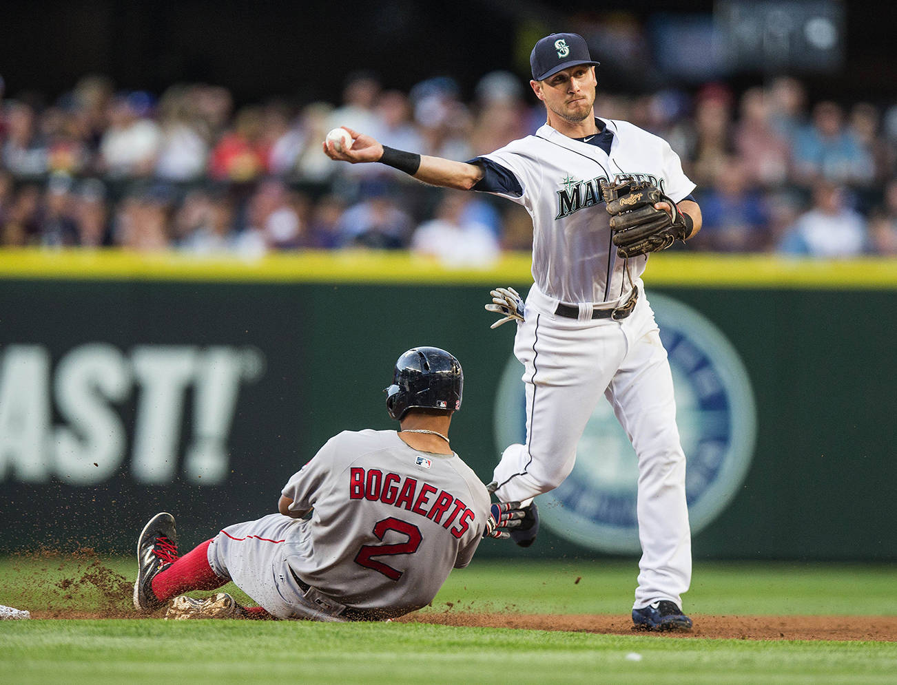 (Dean Rutz | Seattle Times)                                Seattle Mariners infielder Shawn O’Malley turns a double play over the Boston Red Sox’ Xander Bogaerts in the third inning on August 4 at Safeco Field in Seattle. O’Malley and Taylor Motter are in a fight for the team’s utility player spot on the roster this spring.