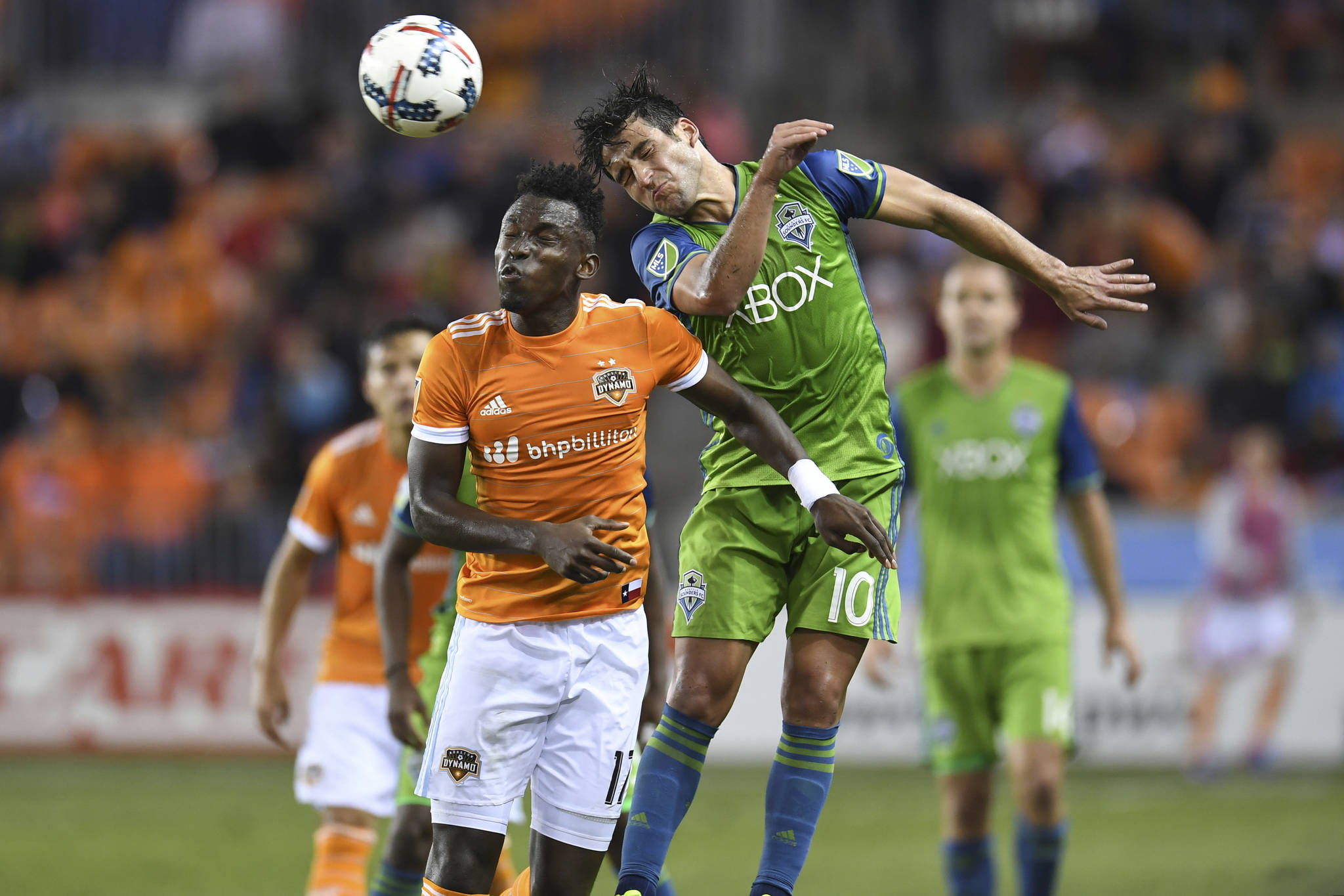 (Trask Smith | Sounders FC Communications) Seattle Sounders FC midfielder Nico Lodeiro goes up to head the ball against Houston Dynamo’s Romell Quioto on Saturday.