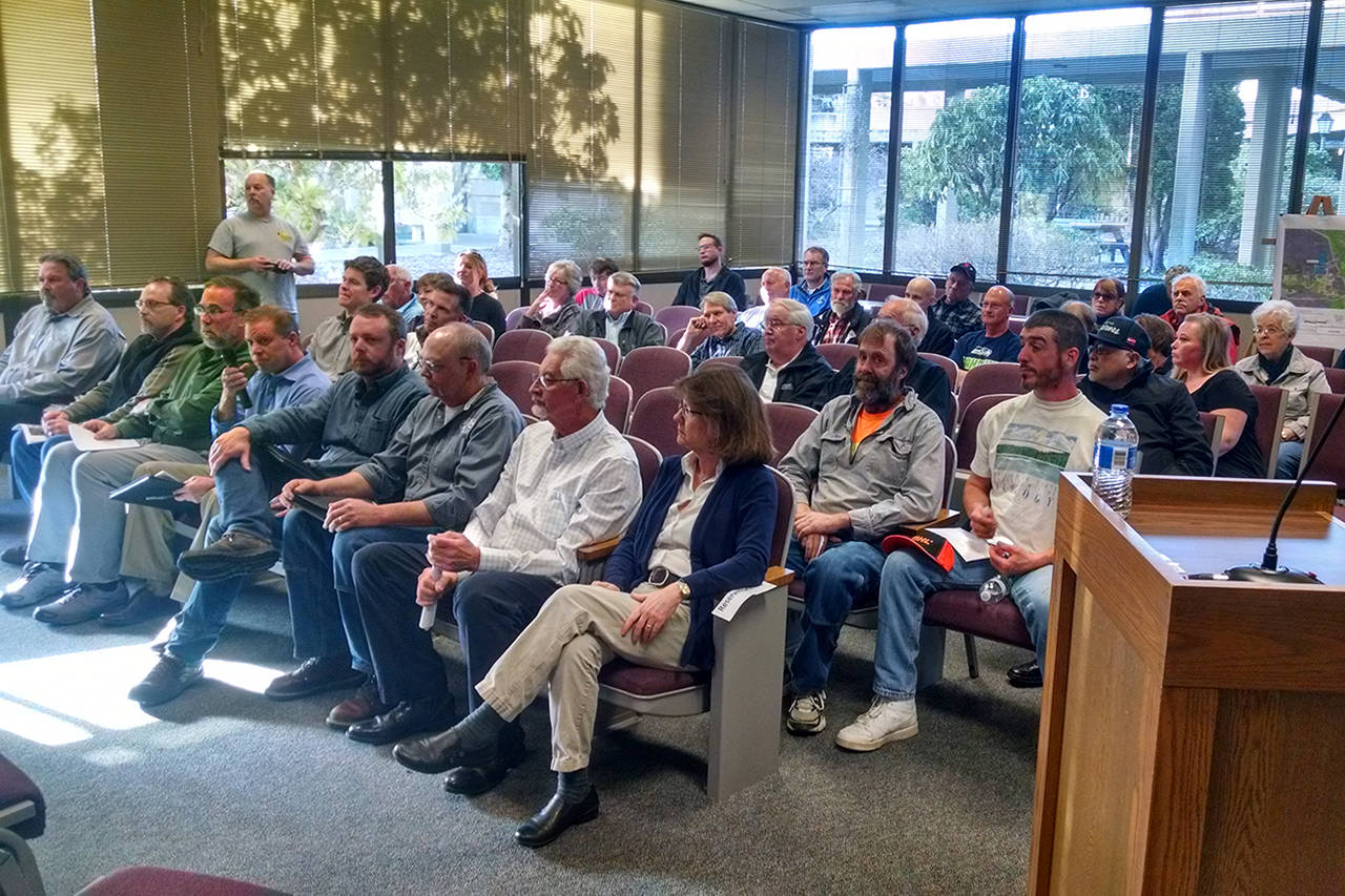 (Corey Morris | The Vidette) Representatives of the Clemons Road transfer station and traffic signal projects (front row) wait for a public meeting to begin. Some 30 community members attended the March 30 meeting.