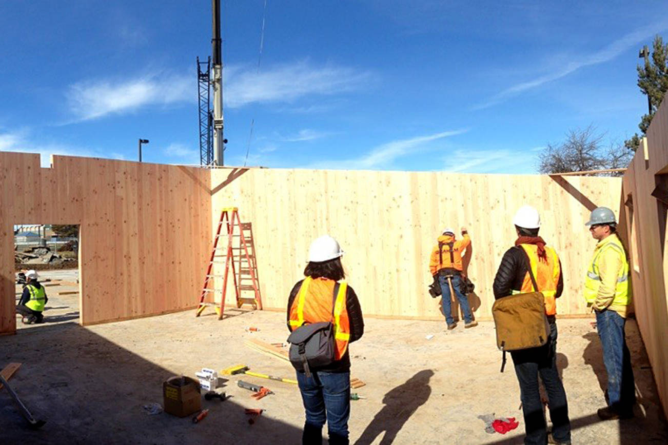 SUSAN JONES PHOTO                                The House capital budget would put a record $1 billion into school construction. Here, workers use cross-laminated timber to build classrooms at Adams Elementary in Wapato. The Legislature has created funding to explore the use of cross-laminated timber - a composite wood building material strong enough to be used in tall buildings - as an environmentally friendly and cost-effective way to address class size issues in the construction of new school facilities.