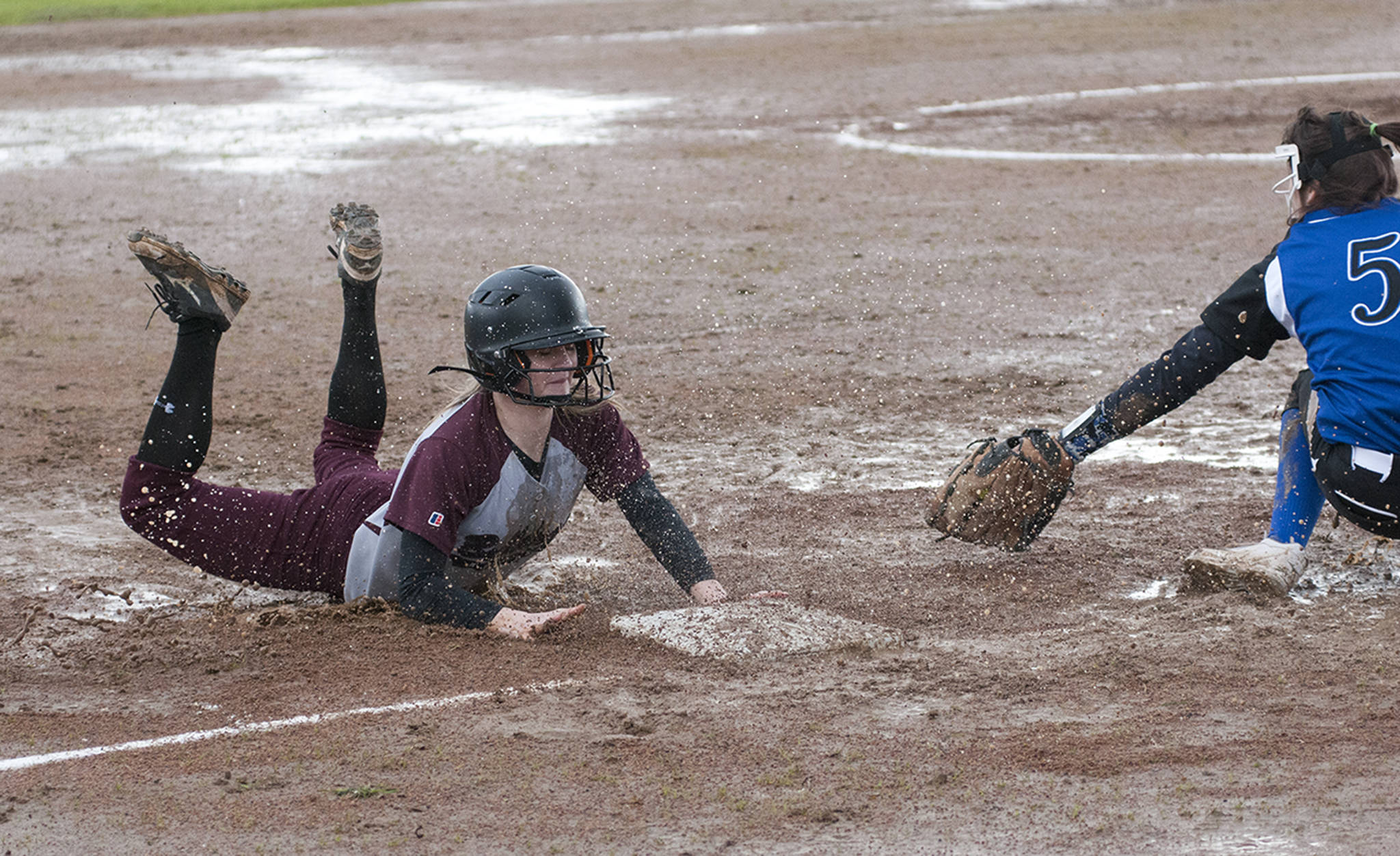 (Brendan Carl | The Daily World) Montesano’s Cheyann Bartlett slides into third base ahead of the tag from Elma’s Kali Rambo during an Evergreen 1A League game on Friday.