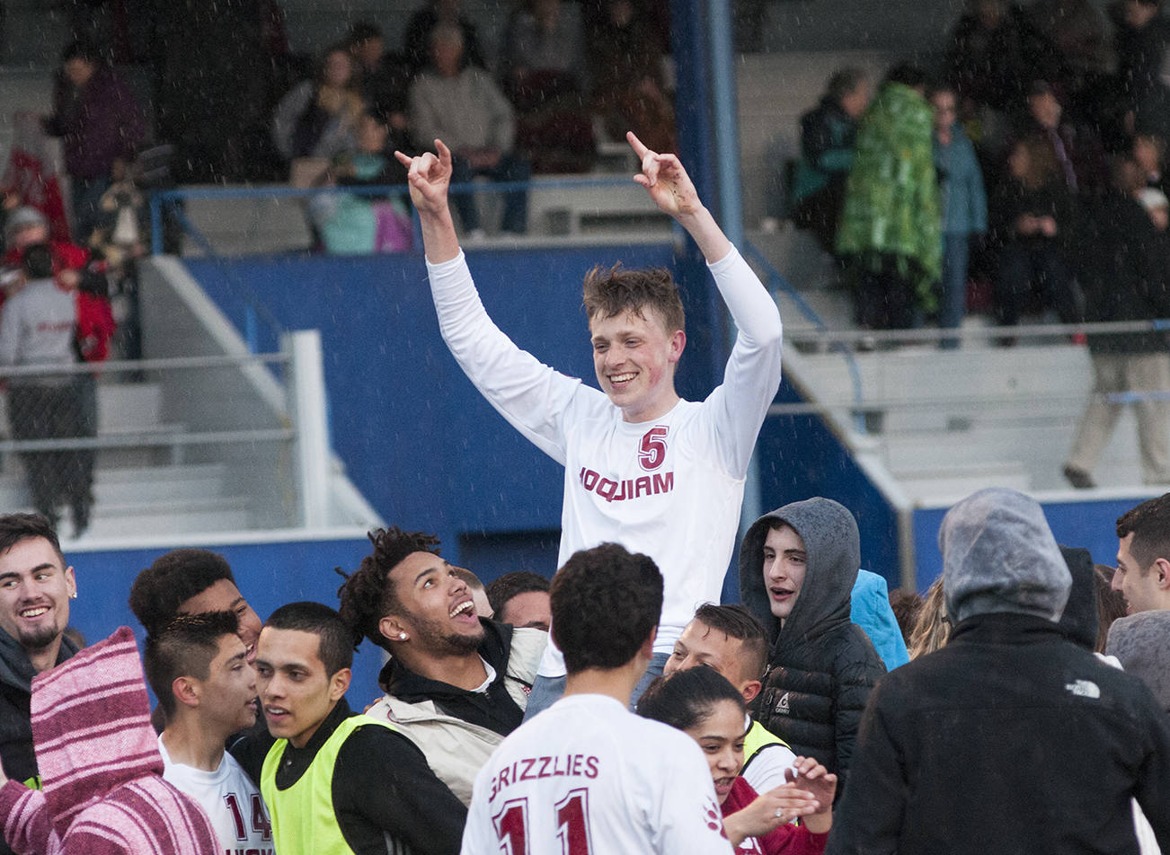 (Brendan Carl | The Daily World) Hoquiam’s Parker McCormick is hoisted up by teammates after making the game-winning penalty kick in the Grizzlies shootout victory over Montesano at Stewart Field on Thursday.