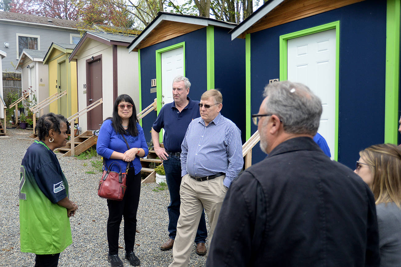 DAN HAMMOCK THE DAILY WORLD                                Sharon Lee, Director of the Low Income Housing Institute, introduced a group from Grays Harbor to residents of a tiny house village in Seattle. Facing the camera from left are Lee, Tim Quigg and Grays Harbor County Commissioner Randy Ross.