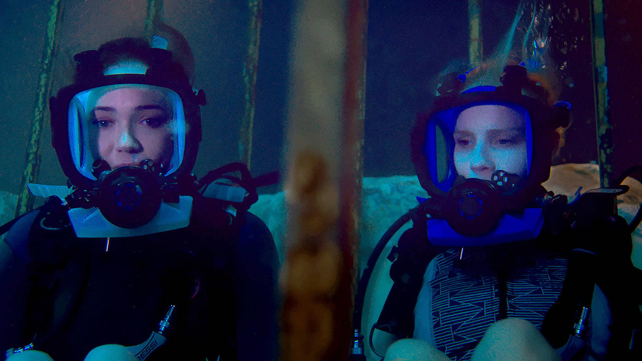 Lisa, played by Mandy Moore, left, and Kate, played by Claire Holt, are stuck on the ocean floor after their shark-diving excursion goes terribly wrong in “47 Meters Down.” (Entertainment Studios Motion Pictures)