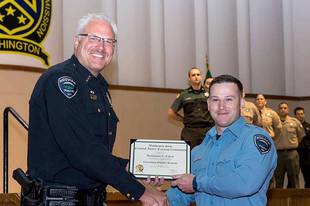 HOQUIAM POLICE DEPARTMENT PHOTO                                Hoquiam Police Chief congratulates officer Ben Eaton at his graduation from the academy last Friday.