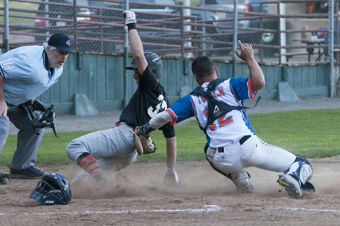 (Brendan Carl | The Daily World) R.B.I.s Ty Reece slides under the tag of Grays Harbor’s Kylan Touch during the first game of a doubleheader on Thursday.