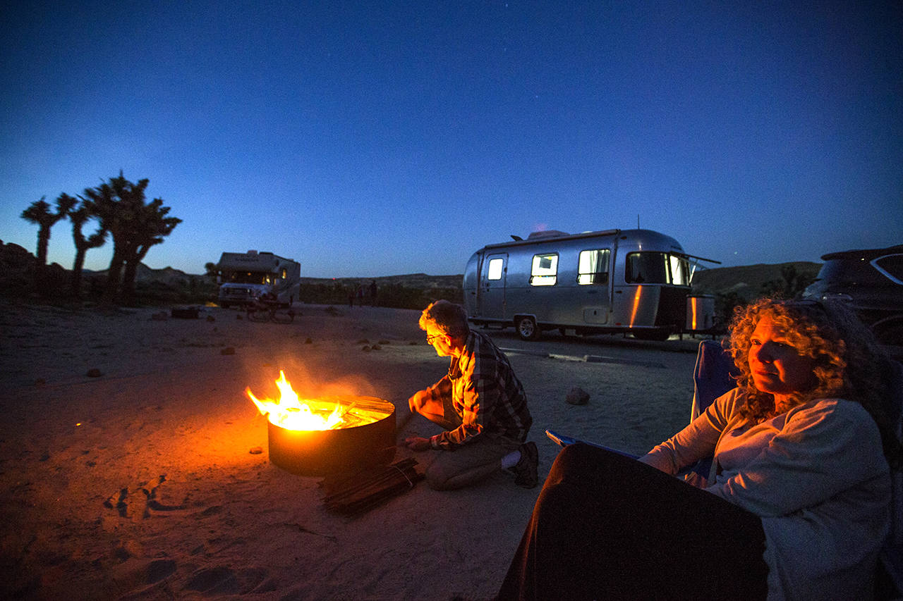 Charles Fleming and Julie Singer check out the stars by a campfire at dusk at Red Rocks Canyon State Park near Mojave, Calif. (Allen J. Schaben/Los Angeles Times)