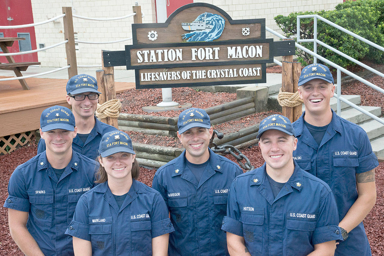 From left, Petty Officer 3rd Class Michael Sparks and Fireman Samuel Ragsdale pose with their rescuers, Fireman Jordan Markland, Petty Officer 2nd Class Tyler McGregor, Petty Officer 2nd Class Zane Hutson and Seaman Crewe Goralski, days after an incident in which two divers were stranded eight miles off Atlantic Beach. (Petty Officer 2nd Class Nate Littlejohn/U.S. Coast Guard)