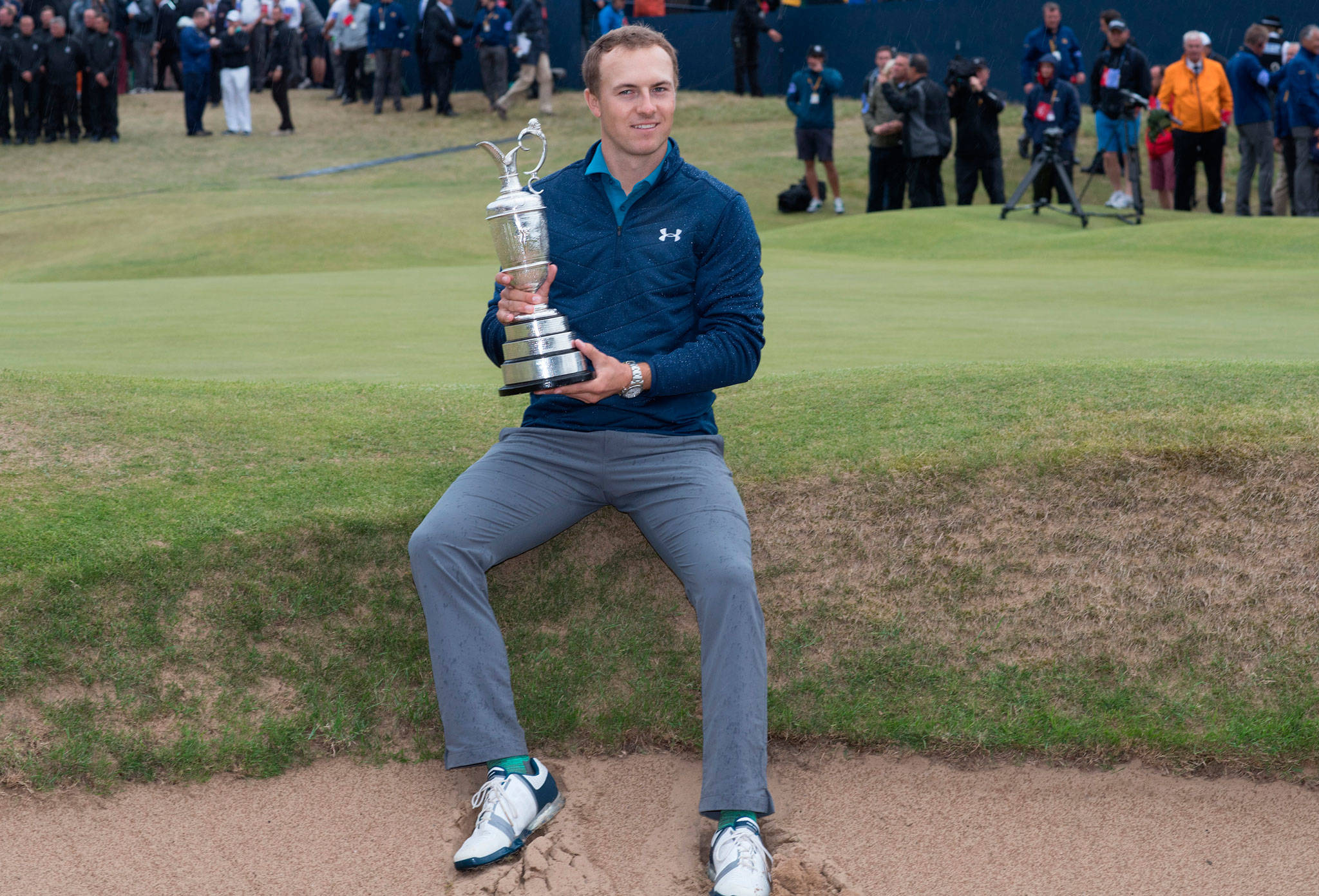 (Rex Shuttlestock | Zuma Press) Jordan Spieth sits down on the lip of a pot bunker near the 18th green at Royal Birkdale with the Claret Jug on Sunday afternoon in Southport, England. Spieth used a finishing run of 5-under par on the last five holes to win the 146th Open Golf Championship.