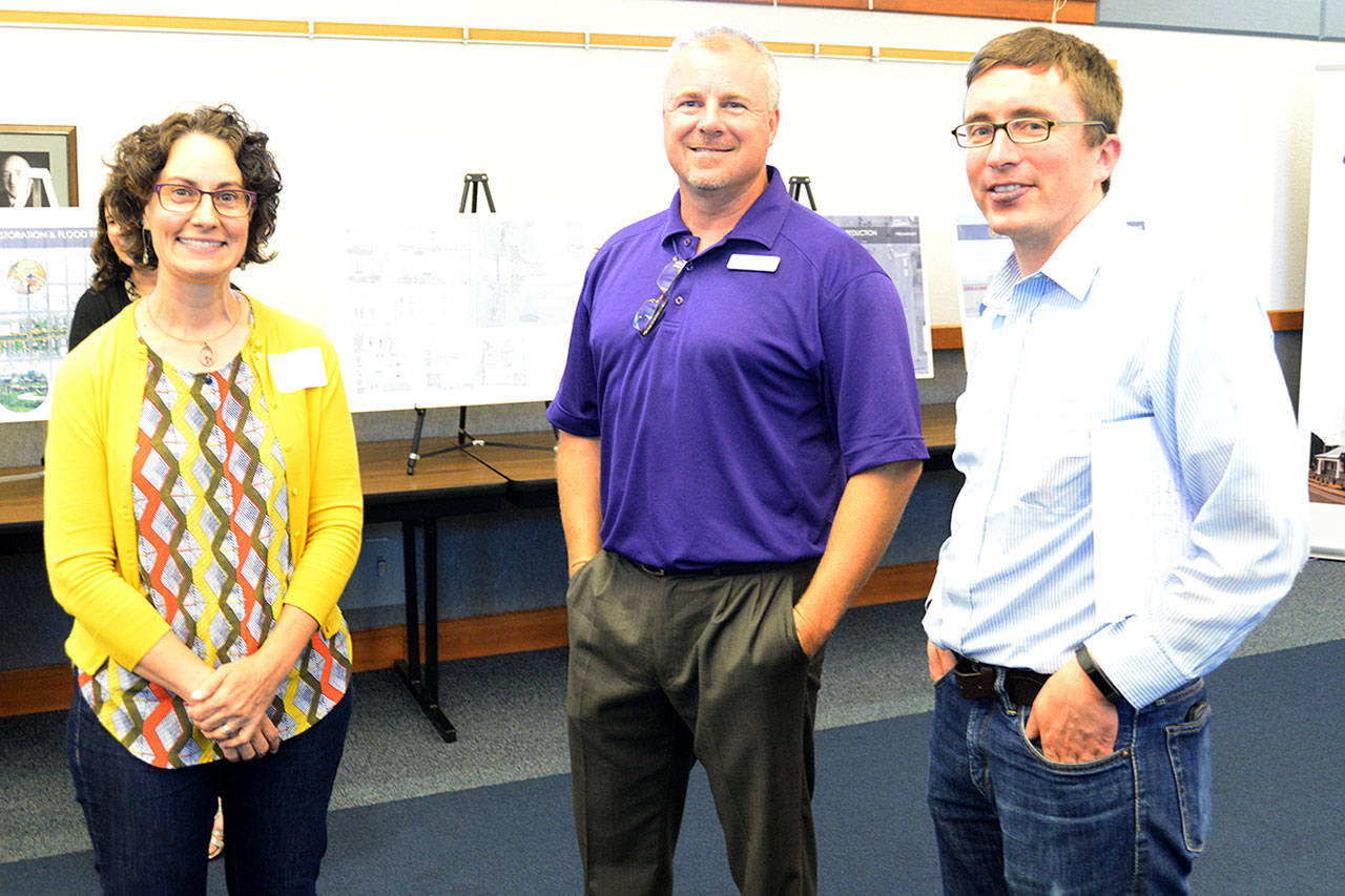 Dan Hammock | The Daily World                                 Planners of the TimberWorks flood mitigation plan took comments from the public at an open house at the Grays Harbor PUD Nichols building Thursday. From left are project engineers Kathy Lombardi and Mark Steepy, and Aberdeen Public Works Engineer Kris Koski.