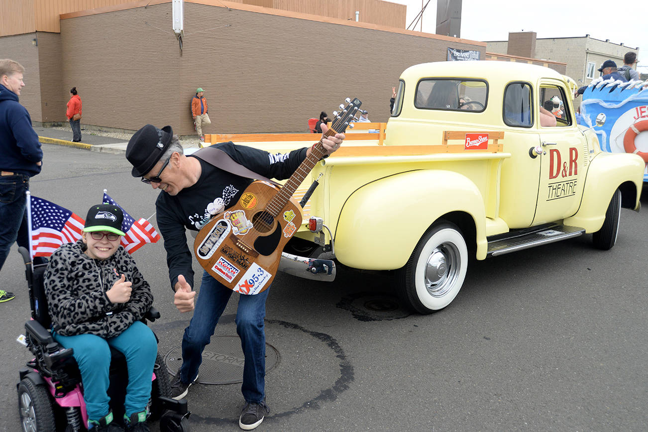DAN HAMMOCK | THE DAILY WORLD                                Local musician and promoter Wil Russoul gets ready to rock the Founders Day Parade with his pal Rashelle Bates Saturday morning in Aberdeen.