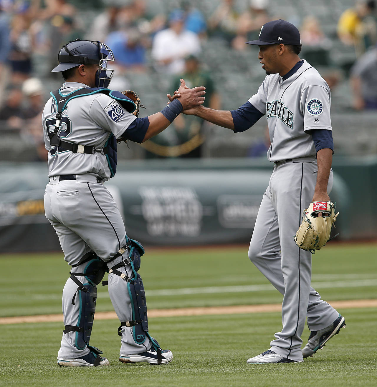 Jane Tyska | Bay Area News Group                                 Mariners reliever Edwin Diaz, right, celebrates with catcher Carlos Ruiz after the final out Wednesday.