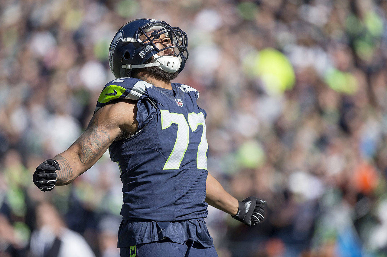 Seattle Seahawks’ Michael Bennett exults after a tackle for loss. (Dean Rutz/Seattle Times)