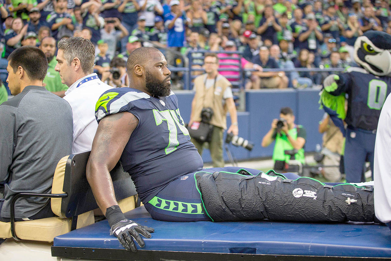 The Seattle Seahawks’ George Fant is carted off the field with a knee injury in the second quarter against the Minnesota Vikings on Friday, Aug. 18, 2017, at CenturyLink Field in Seattle. (Dean Rutz/Seattle Times/TNS)