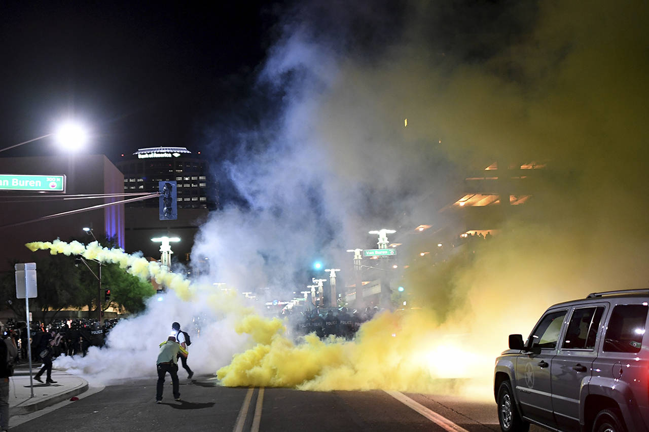 Police fire tear gas at protestors on Tuesday outside the Phoenix Convention Center, where President Donald Trump spoke. (Wally Skalij | Los Angeles Times)