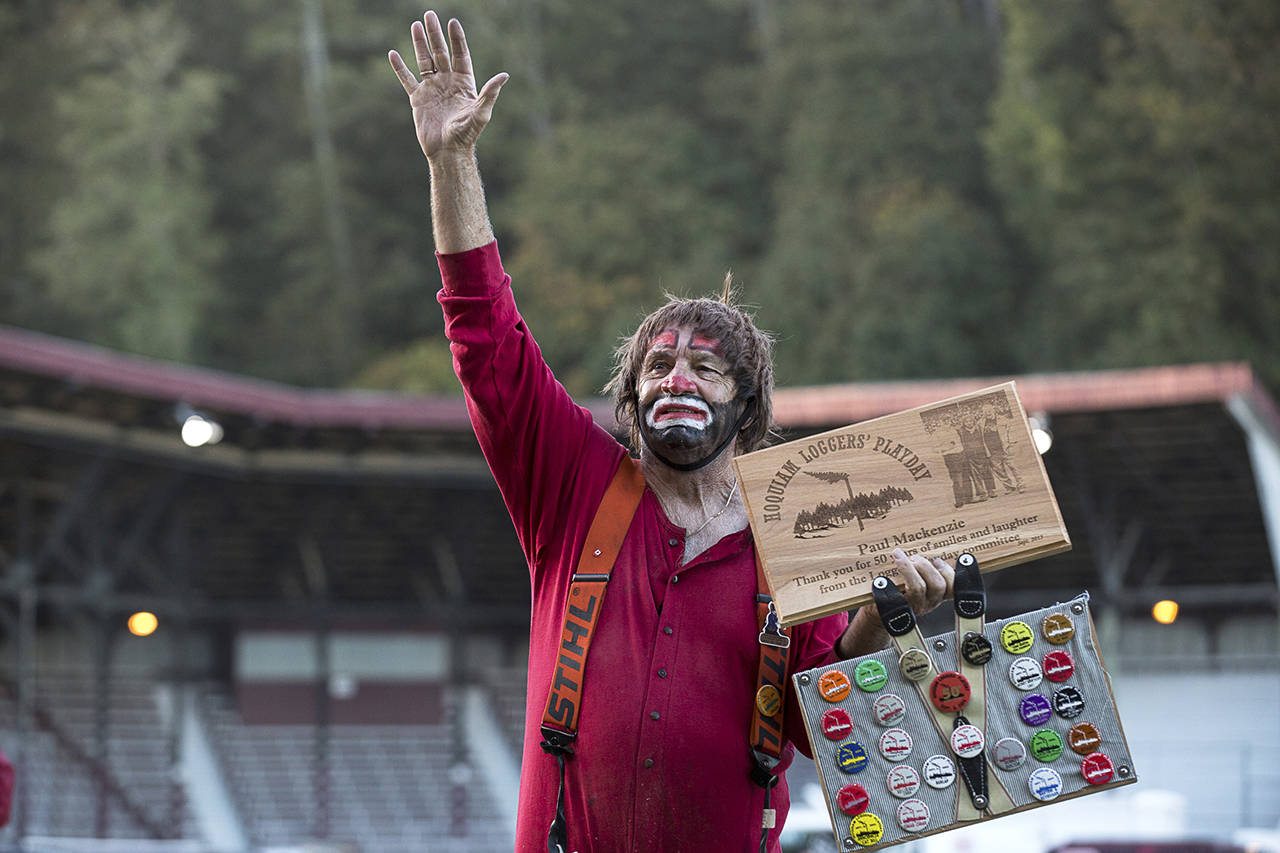 Gabe Green | The Daily World                                Logging clown Paul Mackenzie waves to the crowd in 2015 after receiving a plaque honoring his 50th year of participation in Loggers Playday.